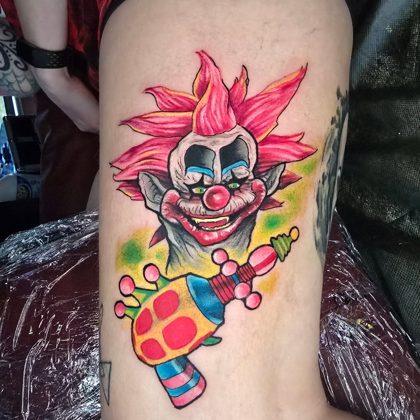Clown with jester hat American traditional tattoo on the thigh by Tivis Phillips