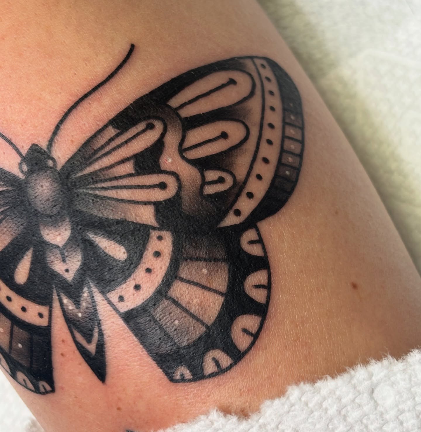 Butterfly black and grey tattoo on the thigh by MJ Saunders