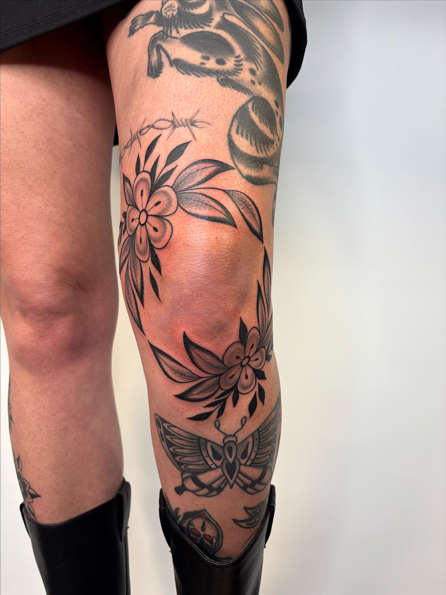 Floral and bird American traditional tattoo on the calf by Victoria Bacon