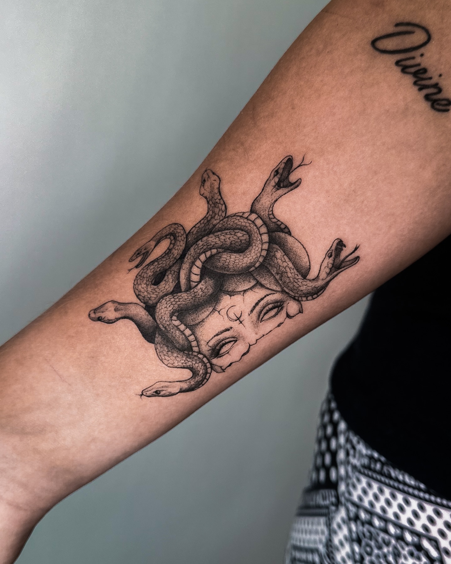 Medusa black and grey tattoo on the forearm by Lauren