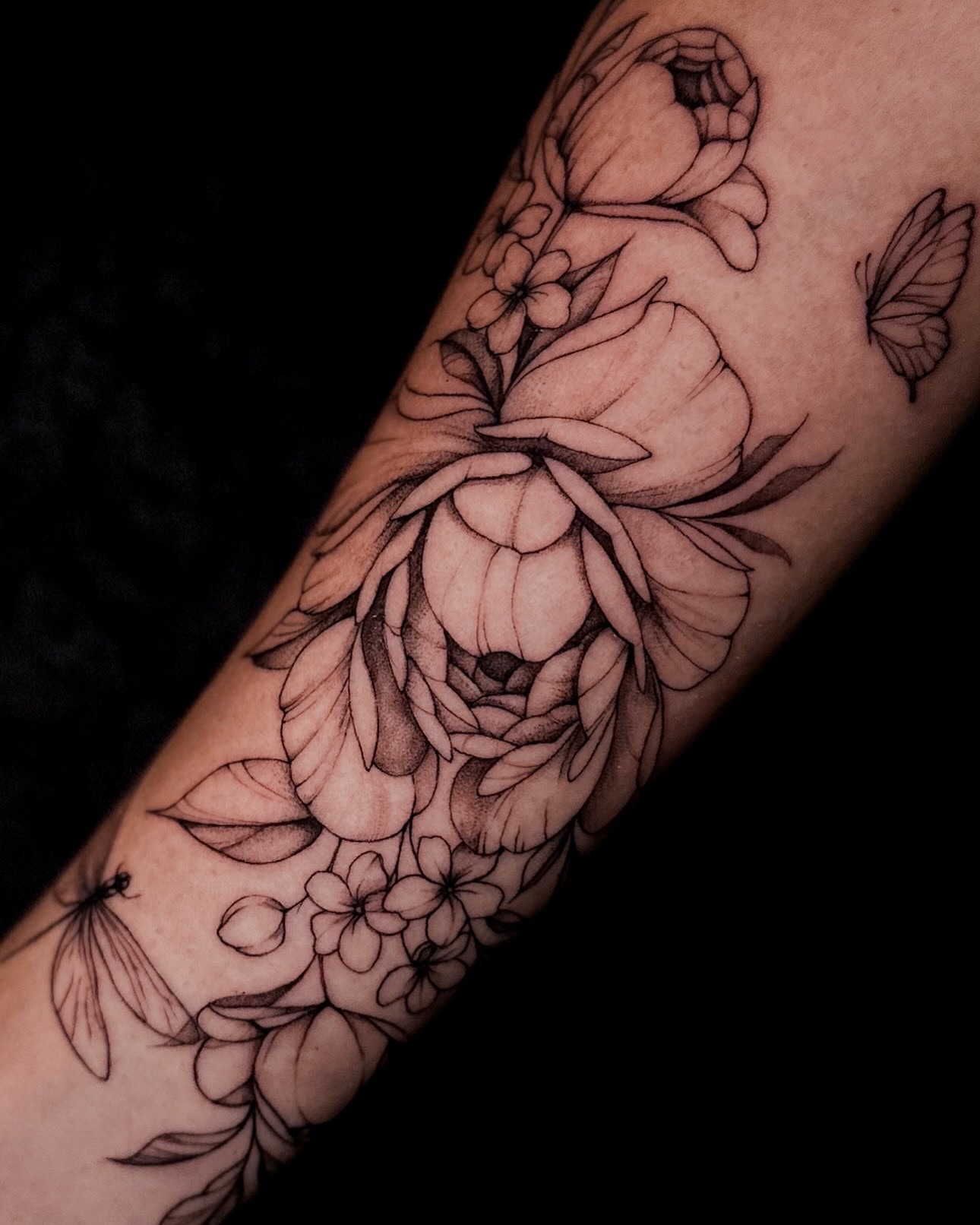 Floral bouquet realism tattoo on the forearm by Lauren
