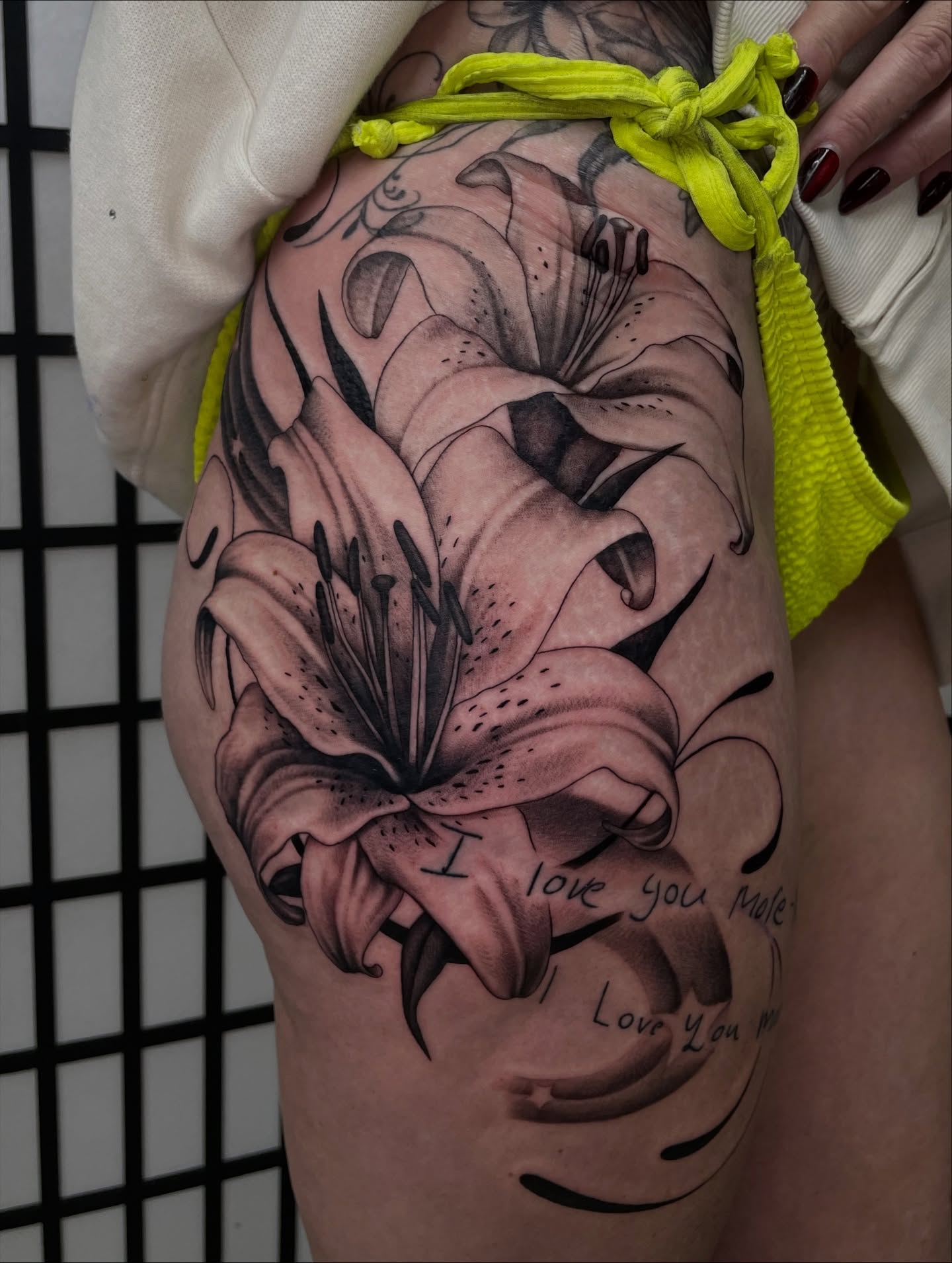 Lilies black and grey tattoo on the thigh by kaylee