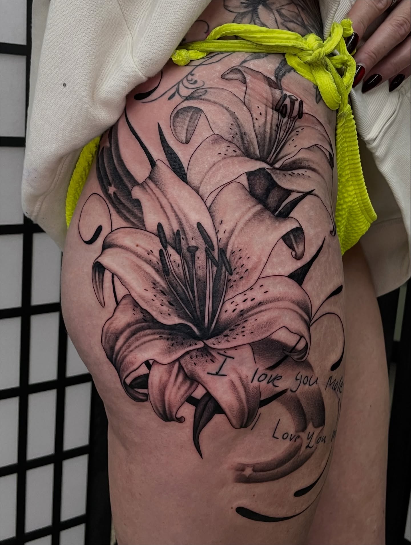 Lilies black and grey tattoo on the thigh by kaylee