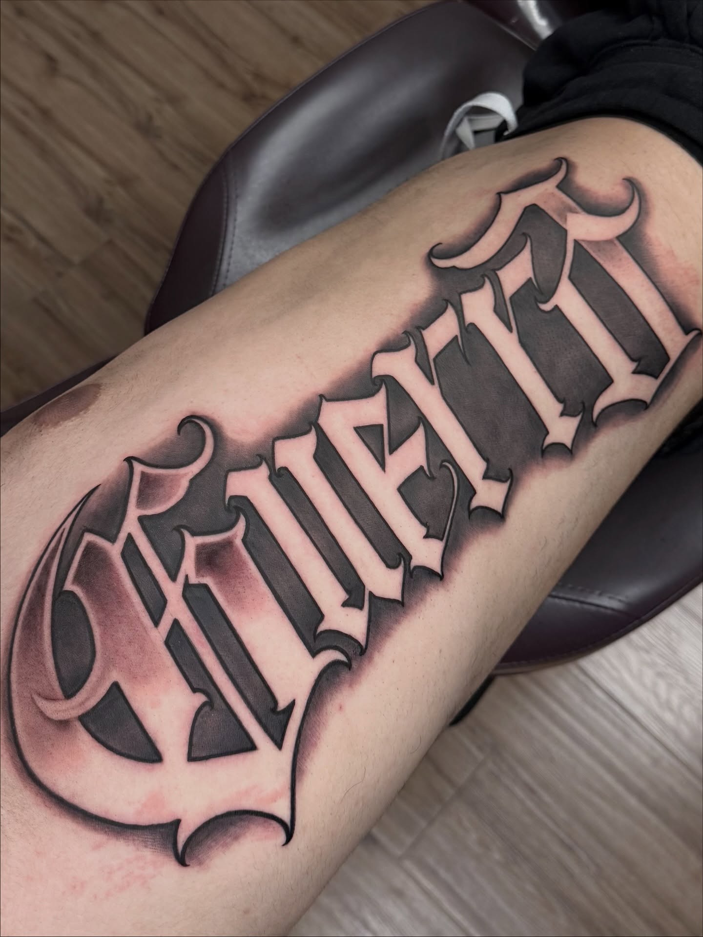 Gothic script tattoo on the leg by Gilberto Flores Nava