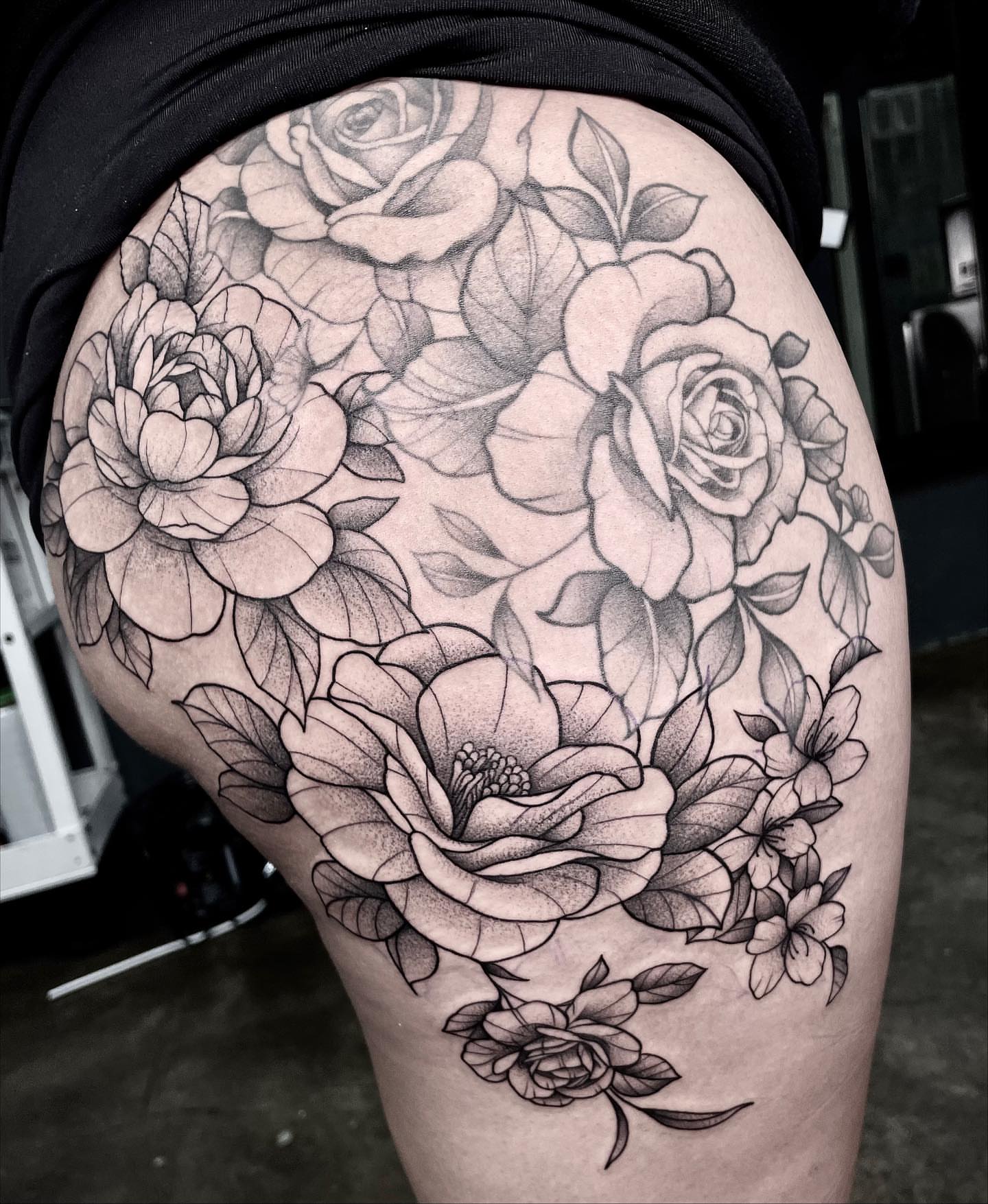 Floral bouquet realism tattoo on the thigh by Ducky