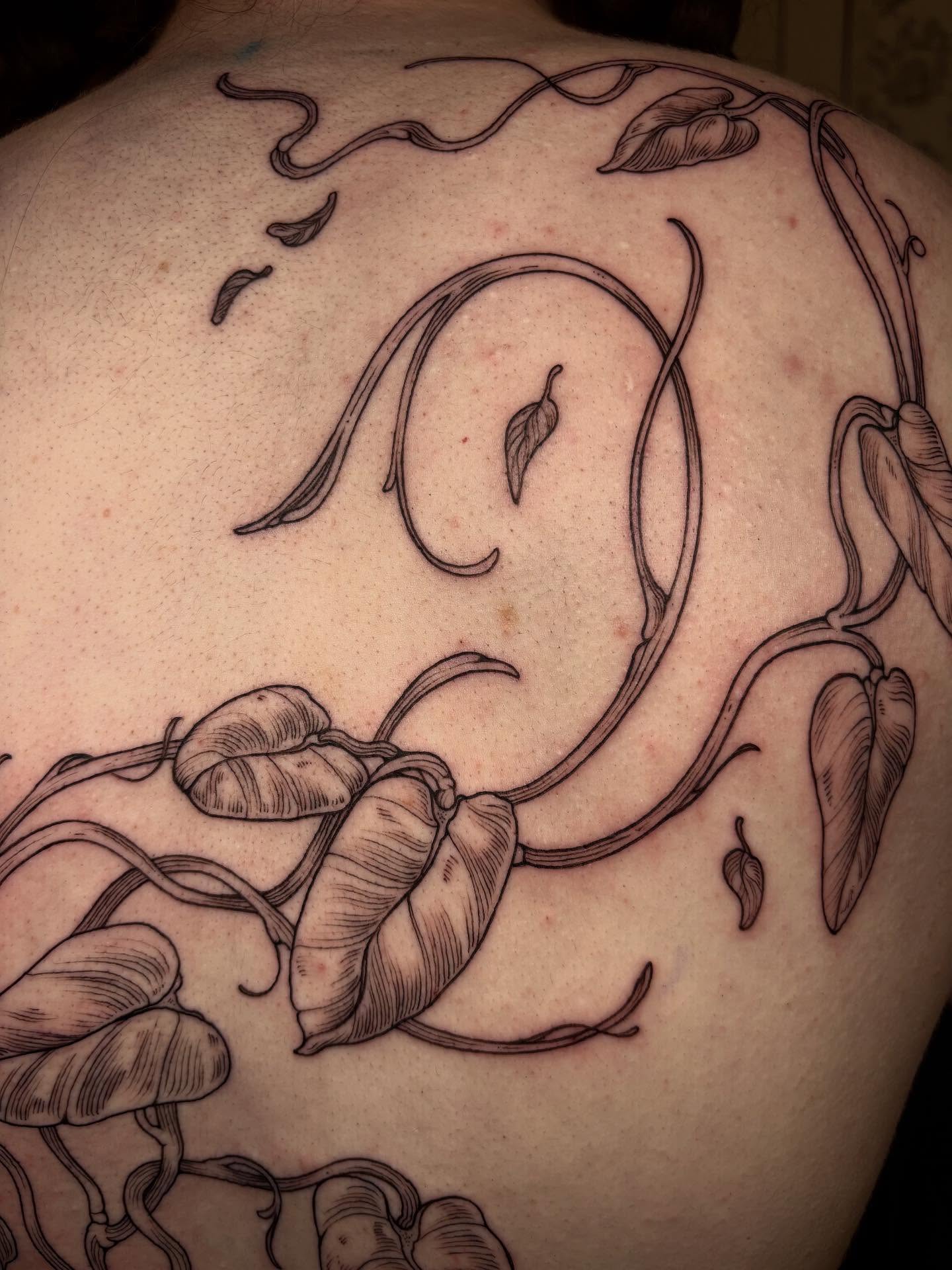 Calla lilies black and grey tattoo on the back by joely