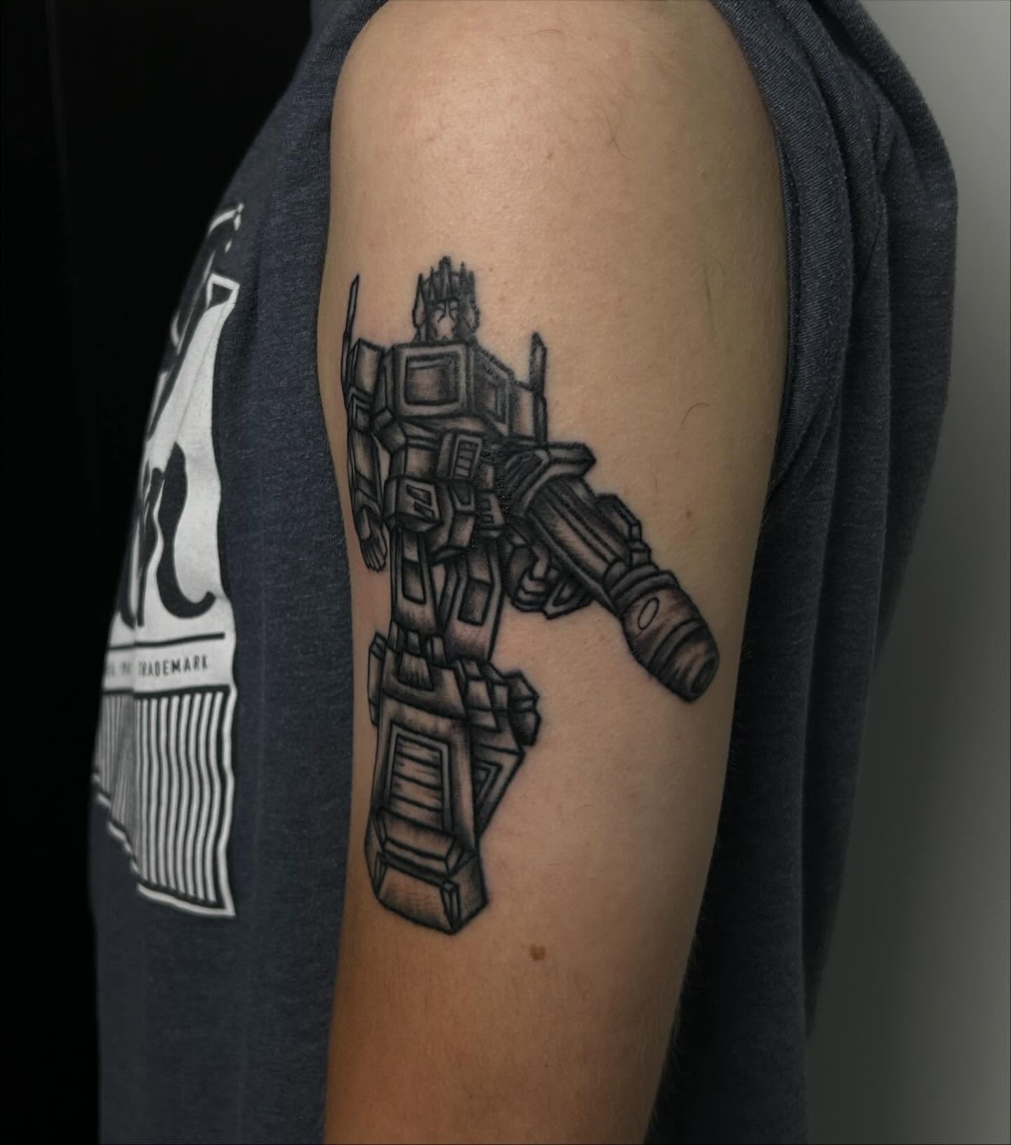 Transformer black and grey tattoo on the forearm by Kenadee