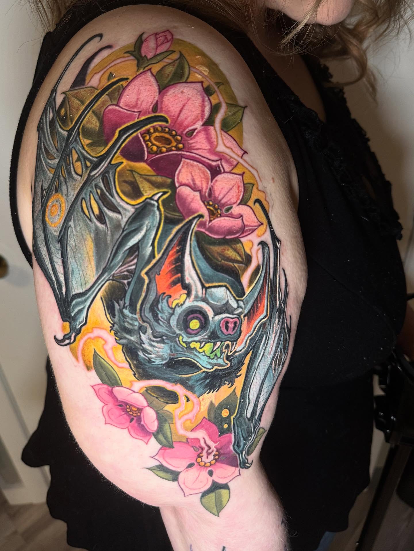 Bat and flowers American traditional tattoo on the shoulder by Zoe "Z" Fisk