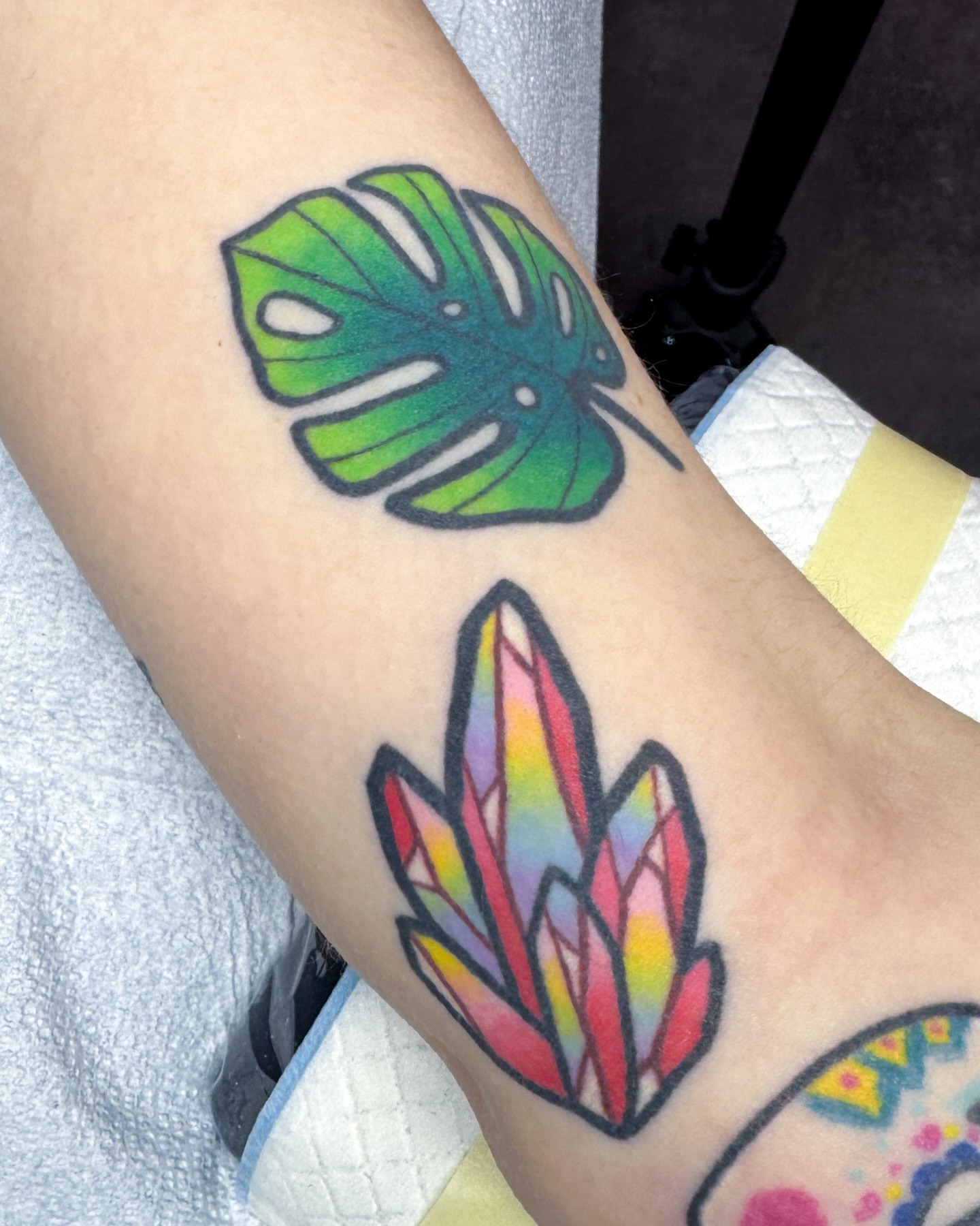 Monstera leaf and crystal geometric tattoo on the forearm by Janine Ramos