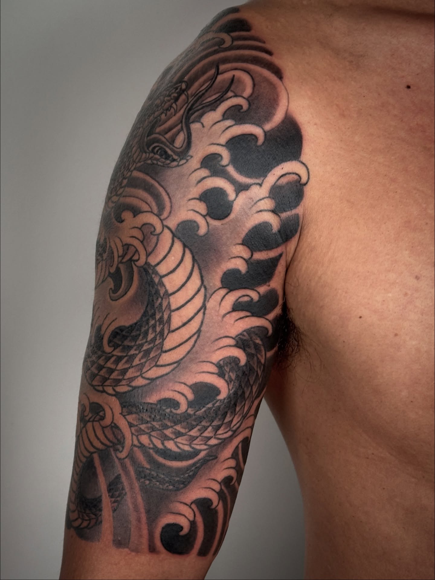 Dragon and waves japanese irezumi tattoo on the upper arm by Tattooer by Trade Wannabe Artist at Heart