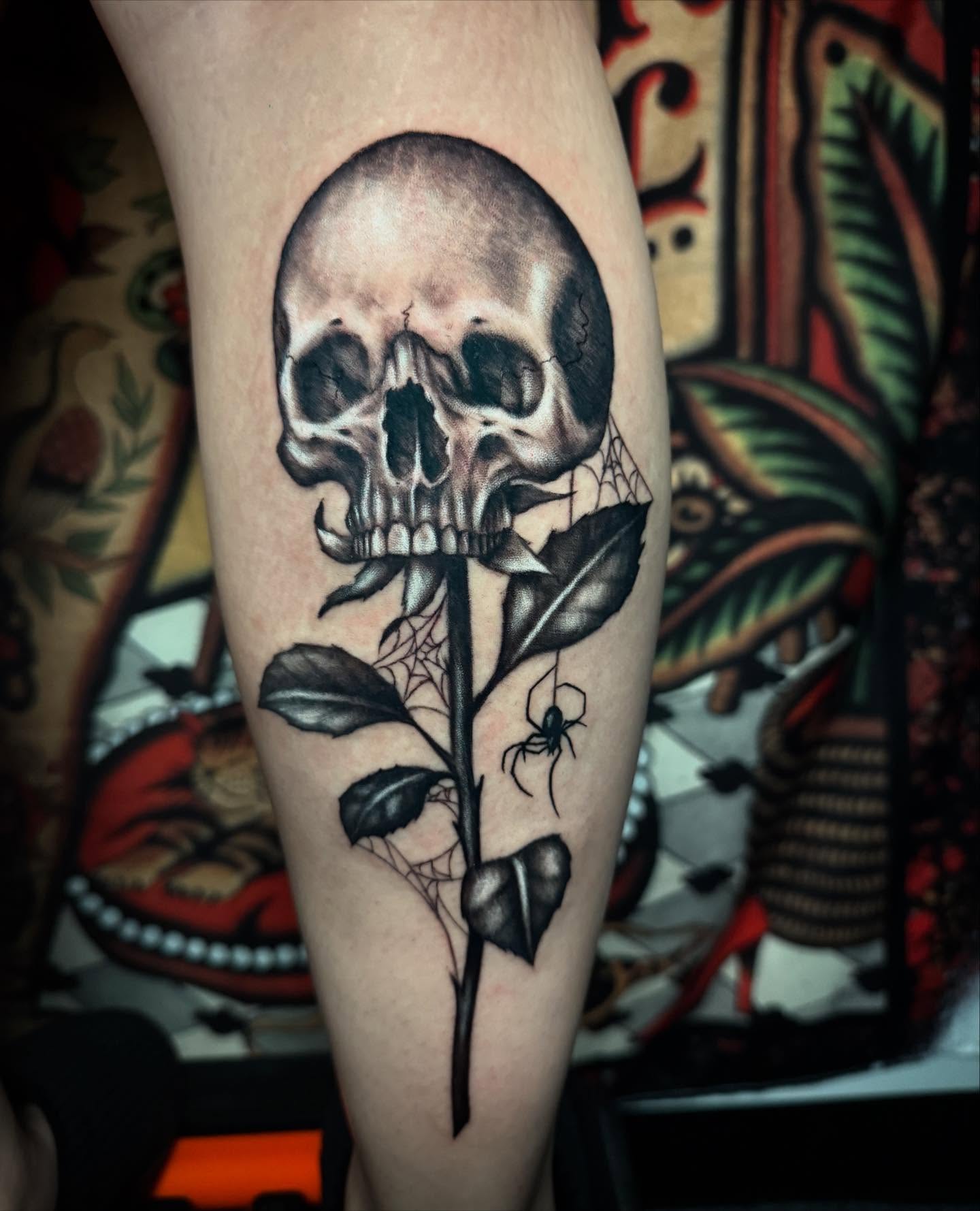Skull and rose American traditional tattoo on the forearm by Alexis Monkiewicz