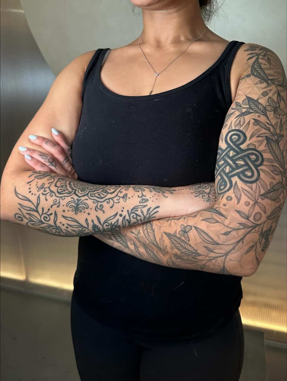 Floral and knotwork geometric tattoo on the upper arm by Carmen Figueroa, New York, New York