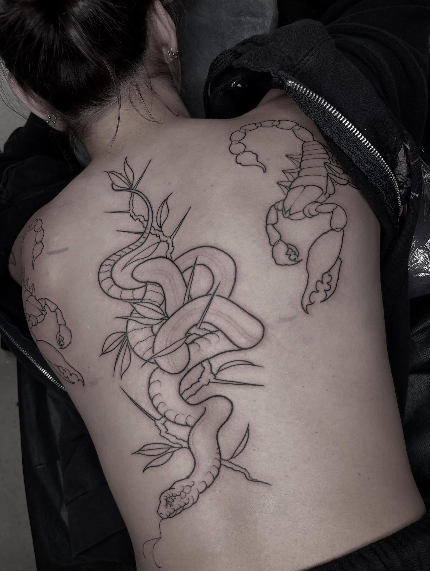 Snake and leaves black and grey tattoo on the back by Allison Gallagher