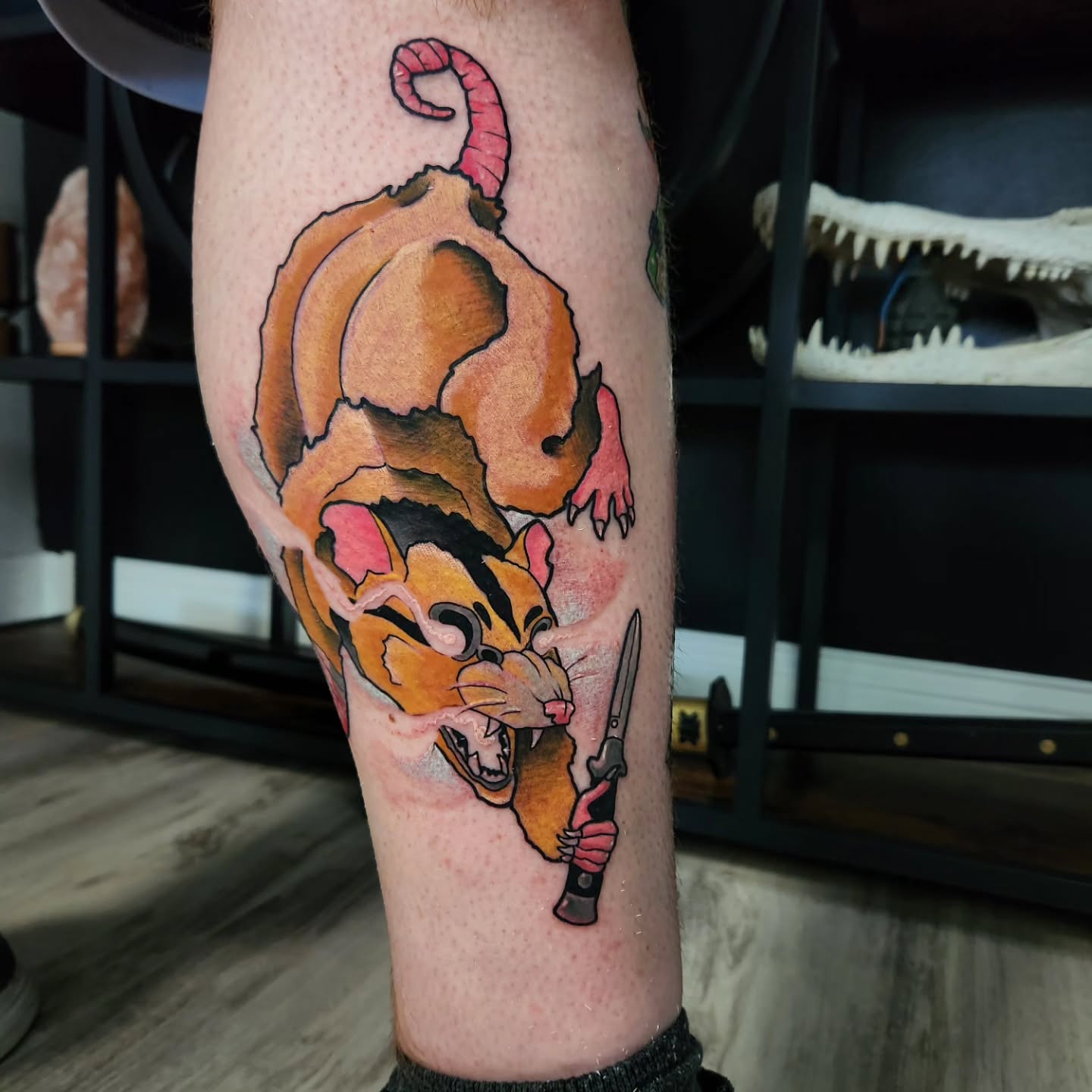 Rat holding a knife American traditional tattoo on the forearm by Geo