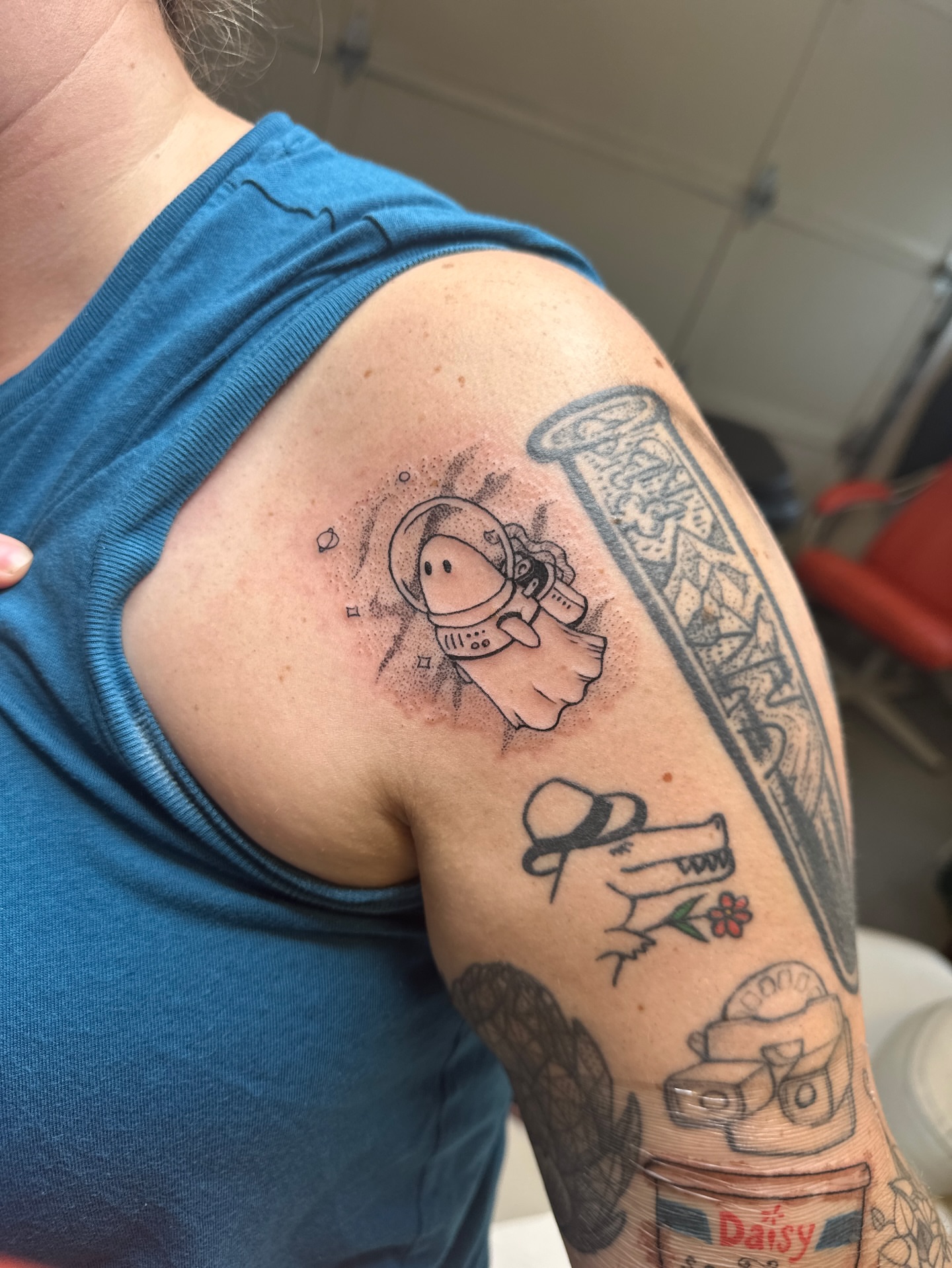 Astronaut and column dotwork tattoo on the shoulder by Emma Berger