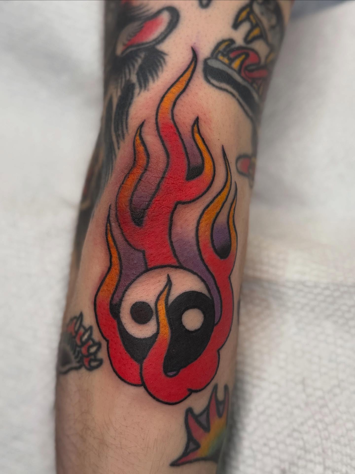 Flaming skull American traditional tattoo on the forearm by Emma Eaton