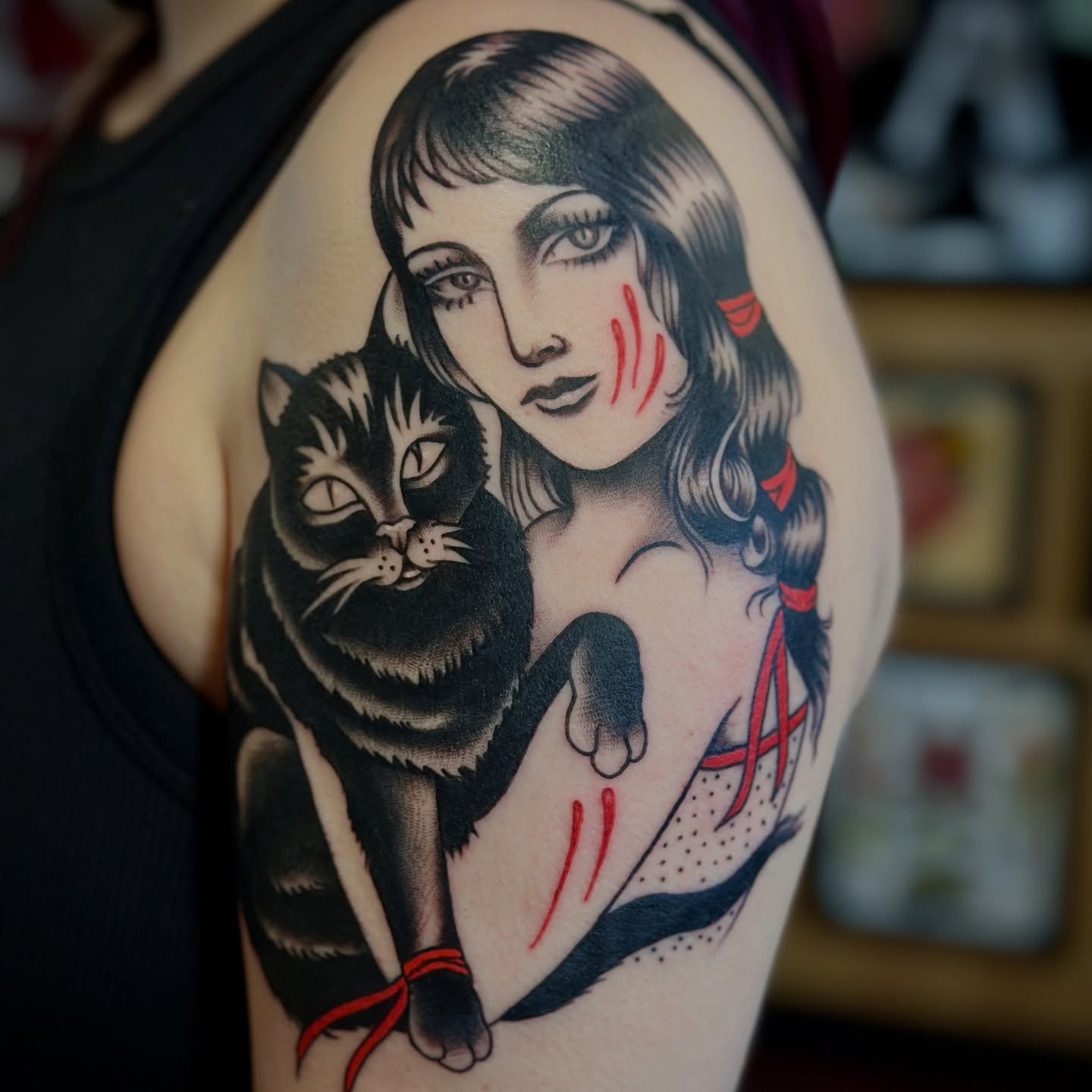 Woman with cat American traditional tattoo on the upper arm by Holly Ellis, San Francisco, California
