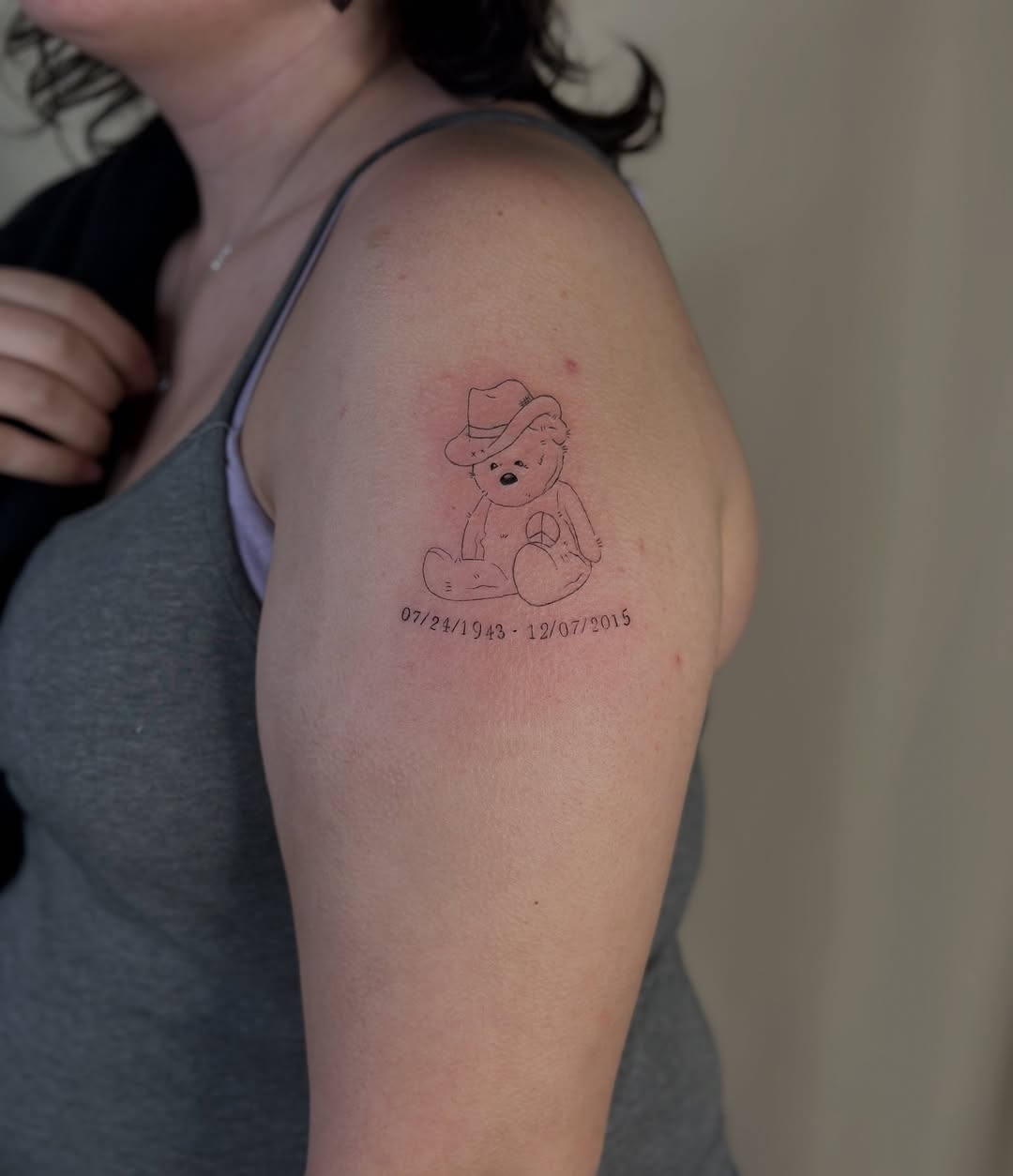 Teddy bear with dates minimalist tattoo on the shoulder by Cherry🥀