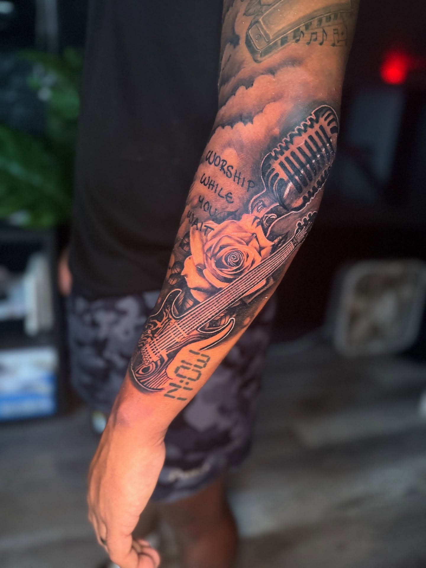Music-themed realism tattoo on the forearm by Atlanta Tattoo Artist