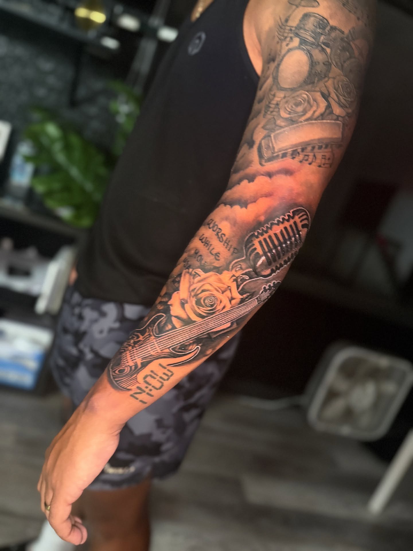 Musician and microphone black and grey tattoo on the forearm by Atlanta Tattoo Artist