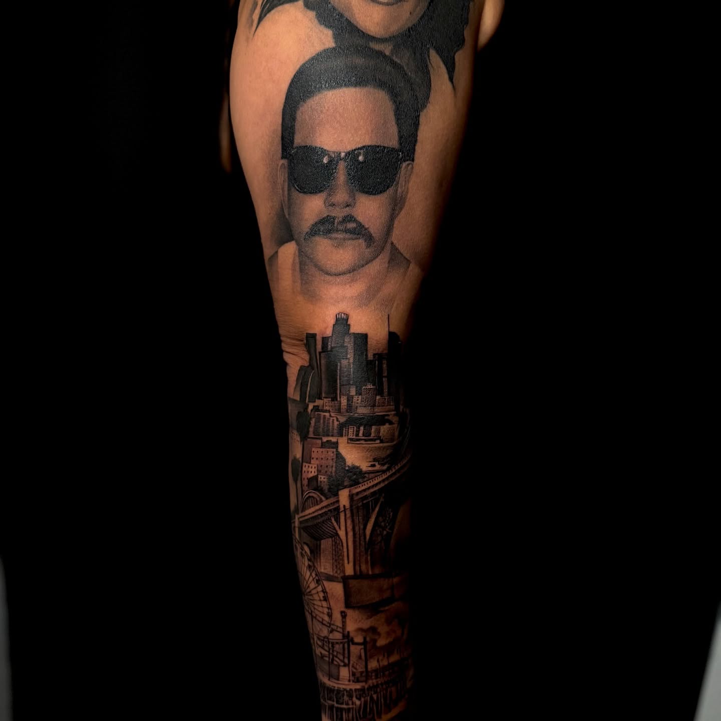 Man with sunglasses realism tattoo on the forearm by tombstone