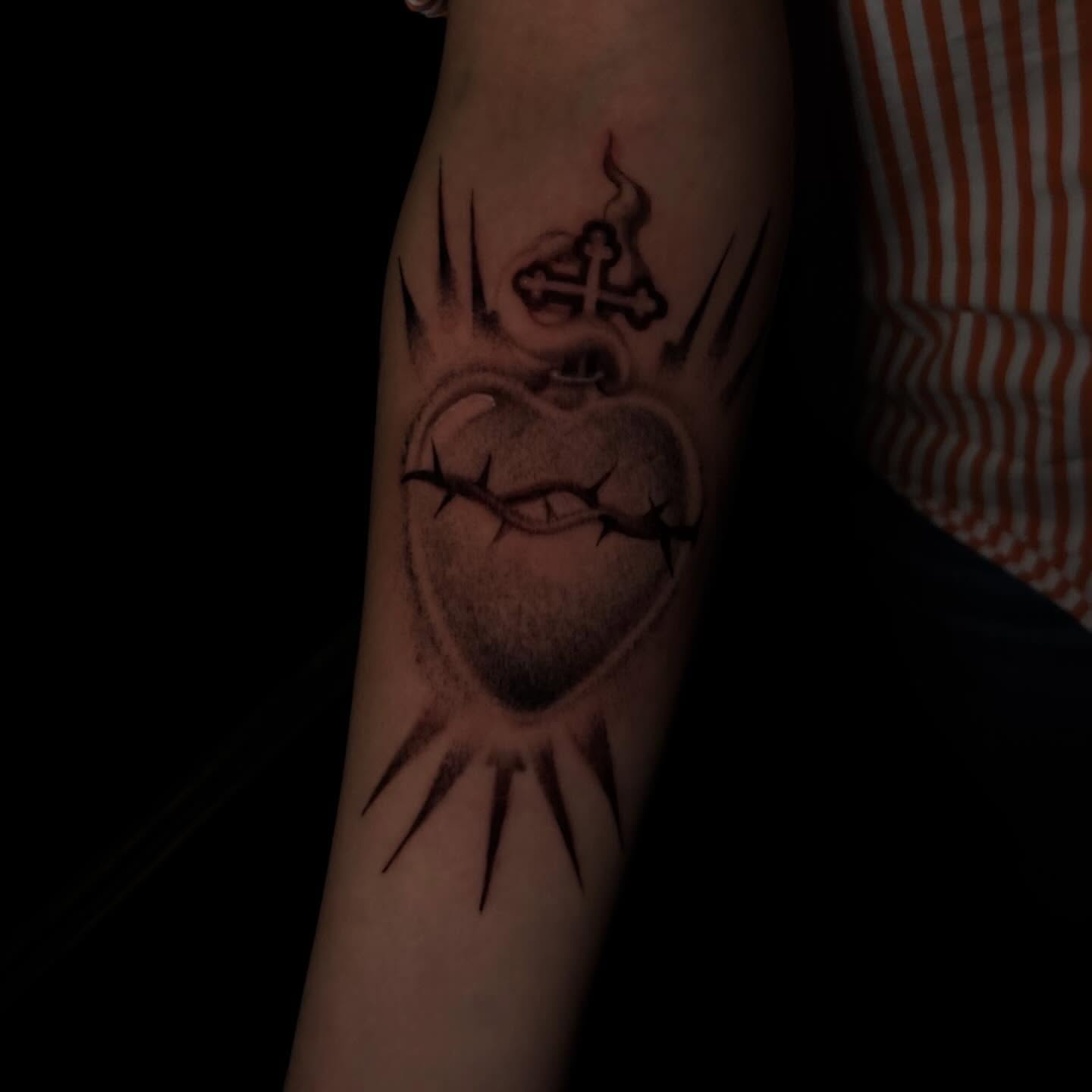 Heart with crown of thorns black and grey tattoo on the forearm by Lee