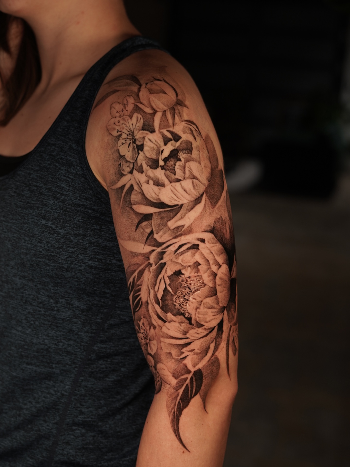Peony flowers realism tattoo on the upper arm by Keely Thompson