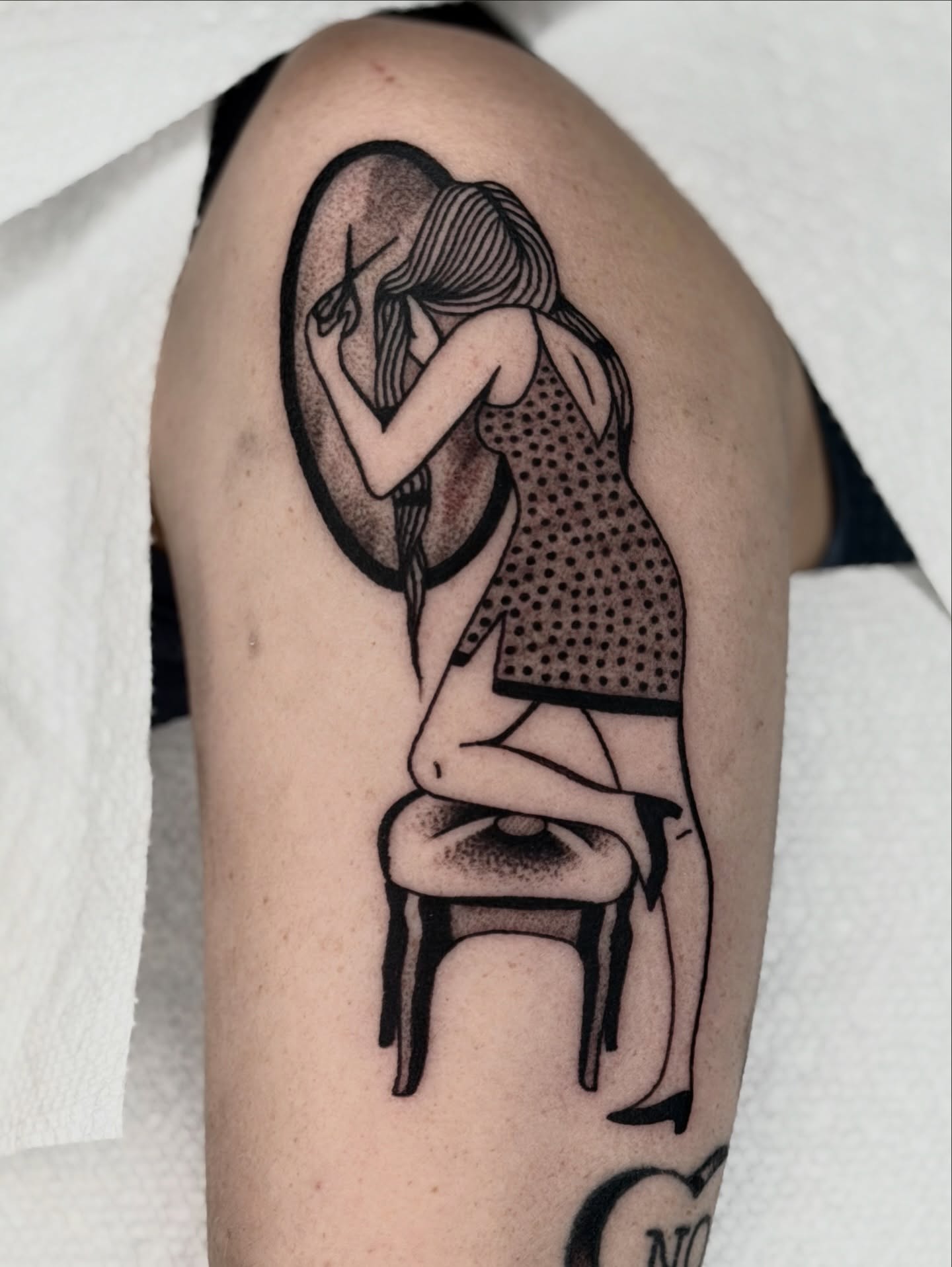Woman sitting dotwork tattoo on the upper arm by Maks