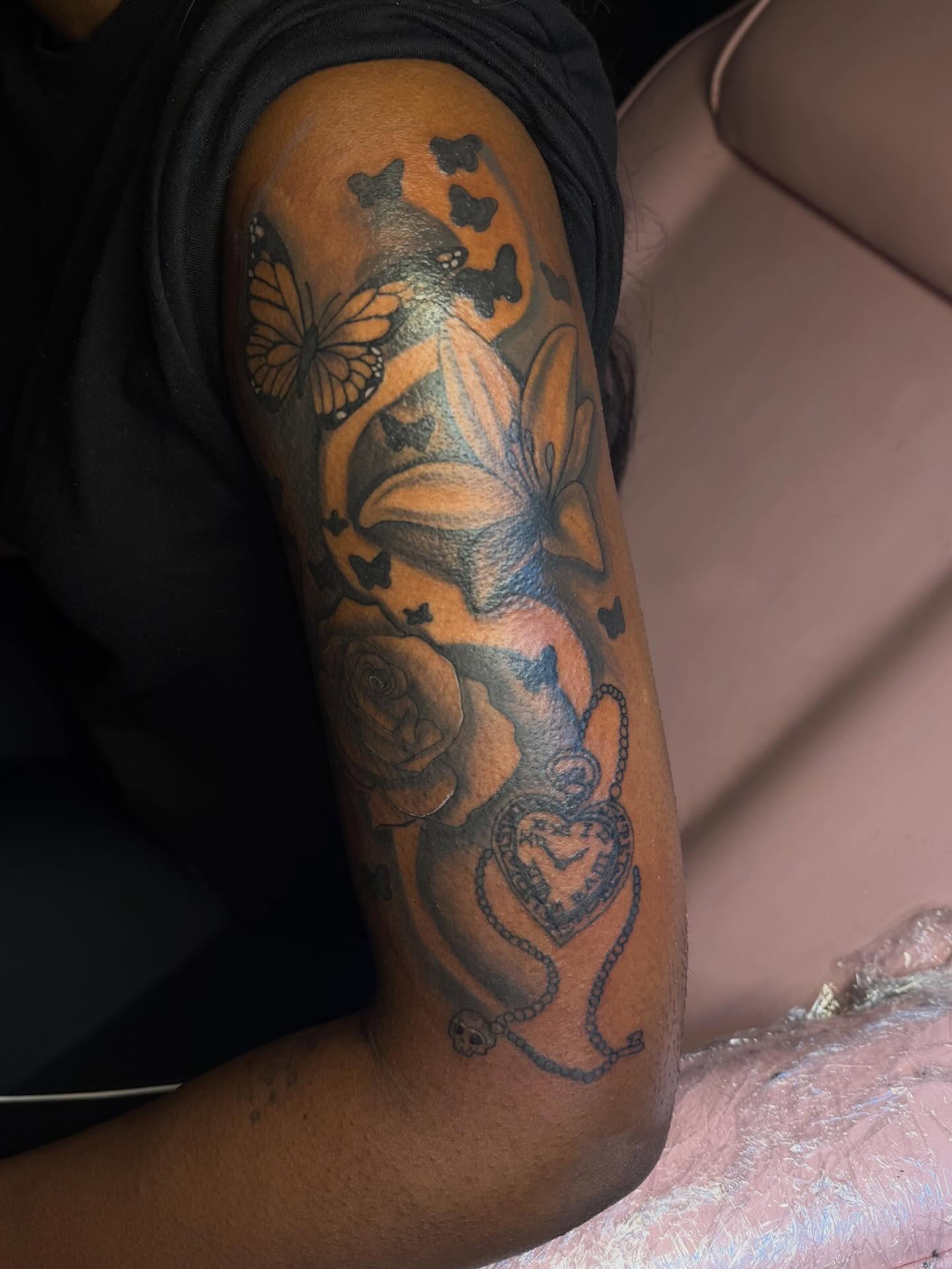 Butterflies and roses black and grey tattoo on the forearm by Tatted By Layy