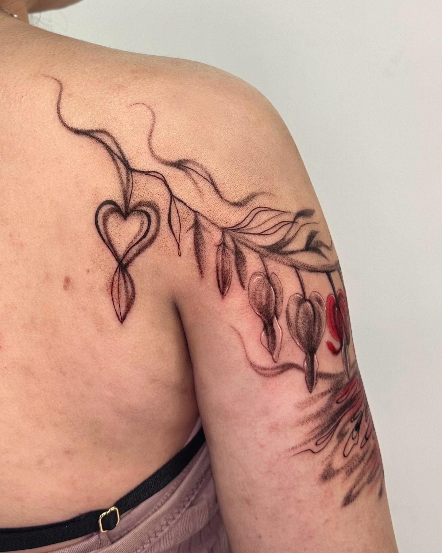 Heart and seed pods black and grey tattoo on the shoulder by Mystikal Blue Casares