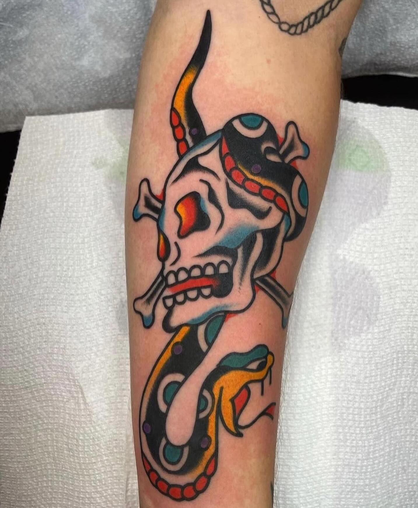 Skull and snake American traditional tattoo on the forearm by Traditional Tattooing