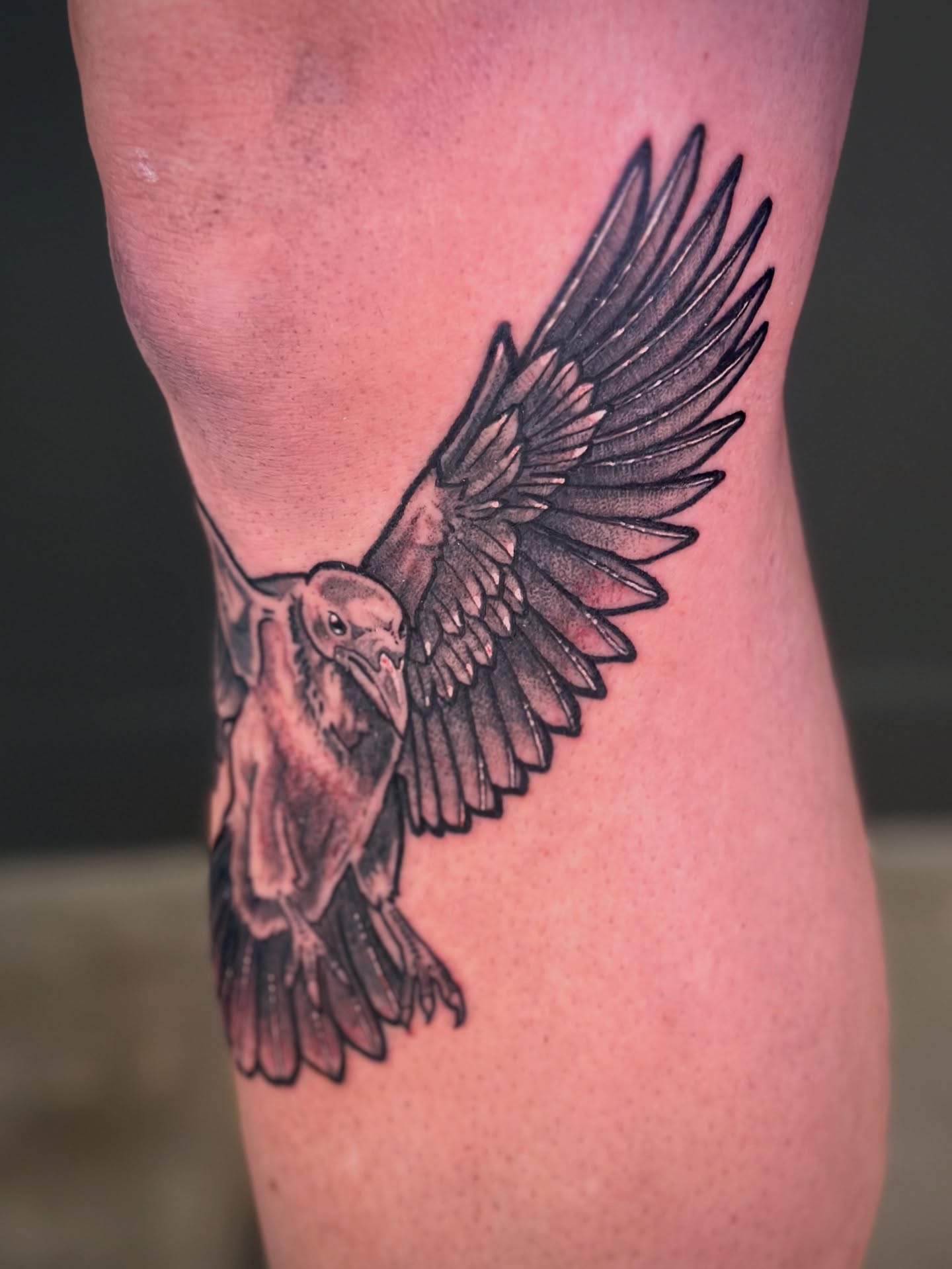 Raven black and grey tattoo on the thigh by Maddie Morrill