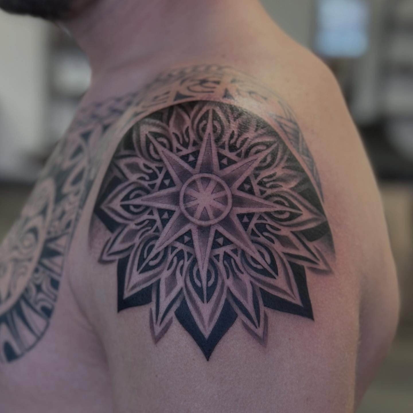 Compass star geometric tattoo on the shoulder by Teddi Bird