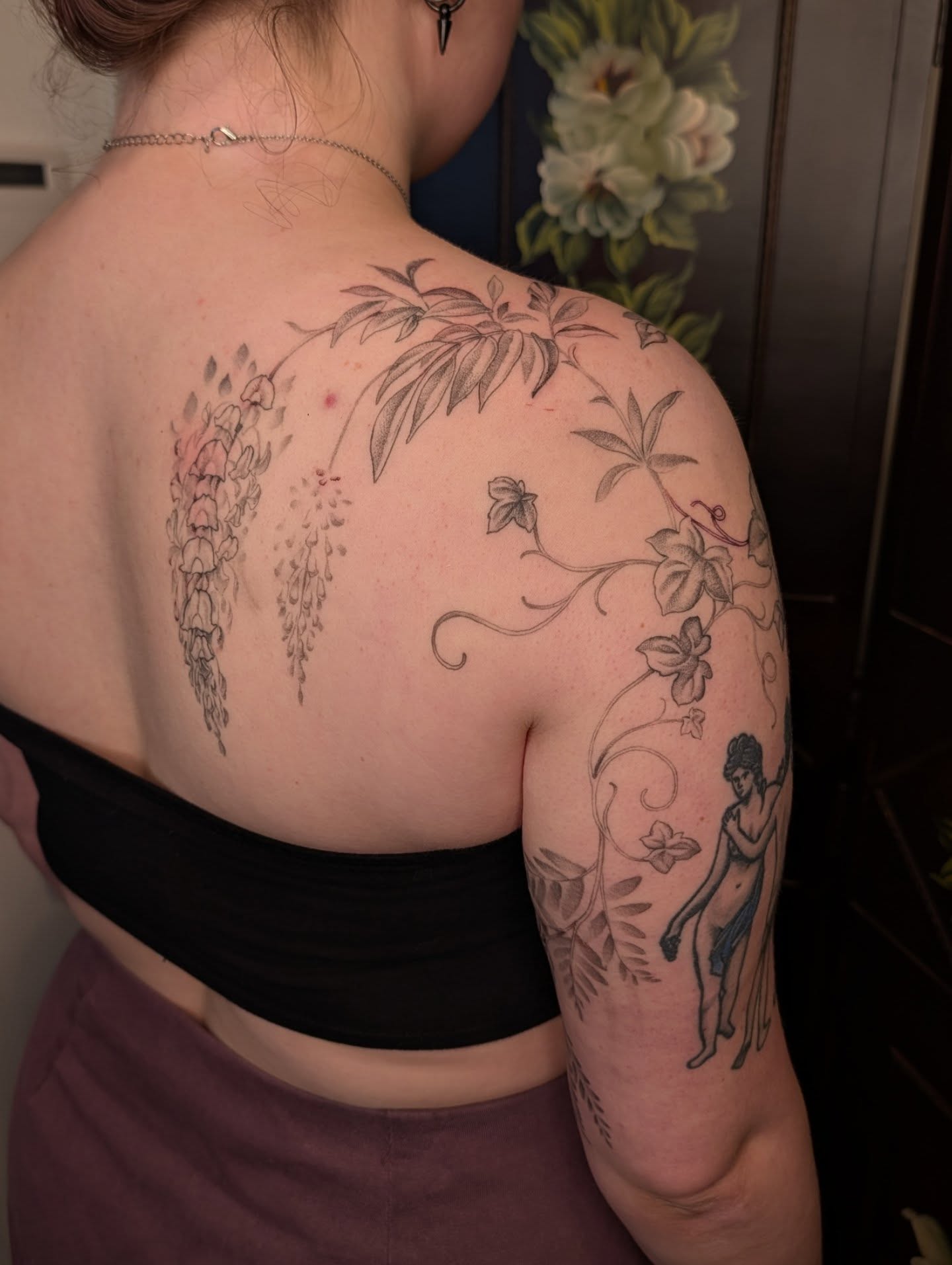 Floral and figure black and grey tattoo on the shoulder by Jeanine, Providence, Rhode Island