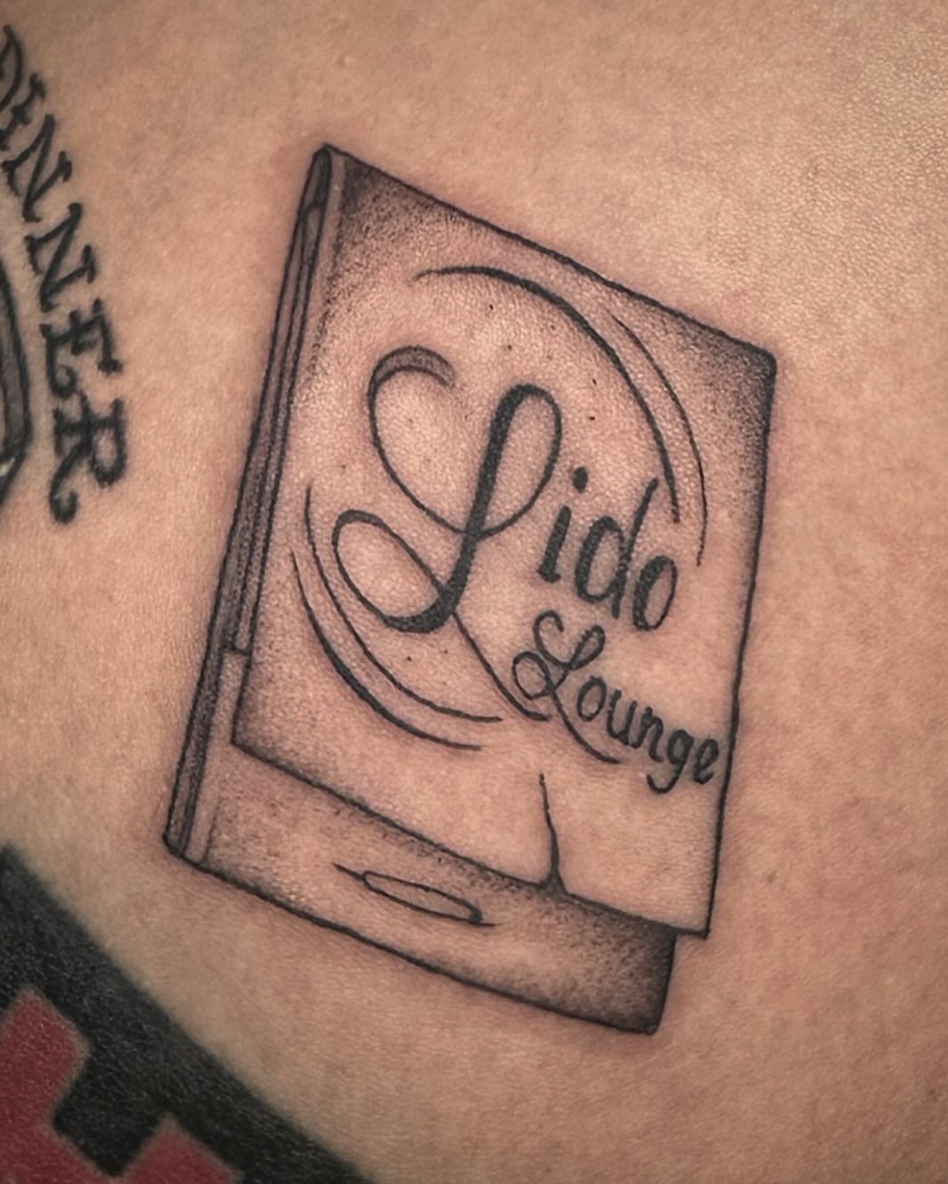 Book black and grey tattoo on the chest by Lia Massari