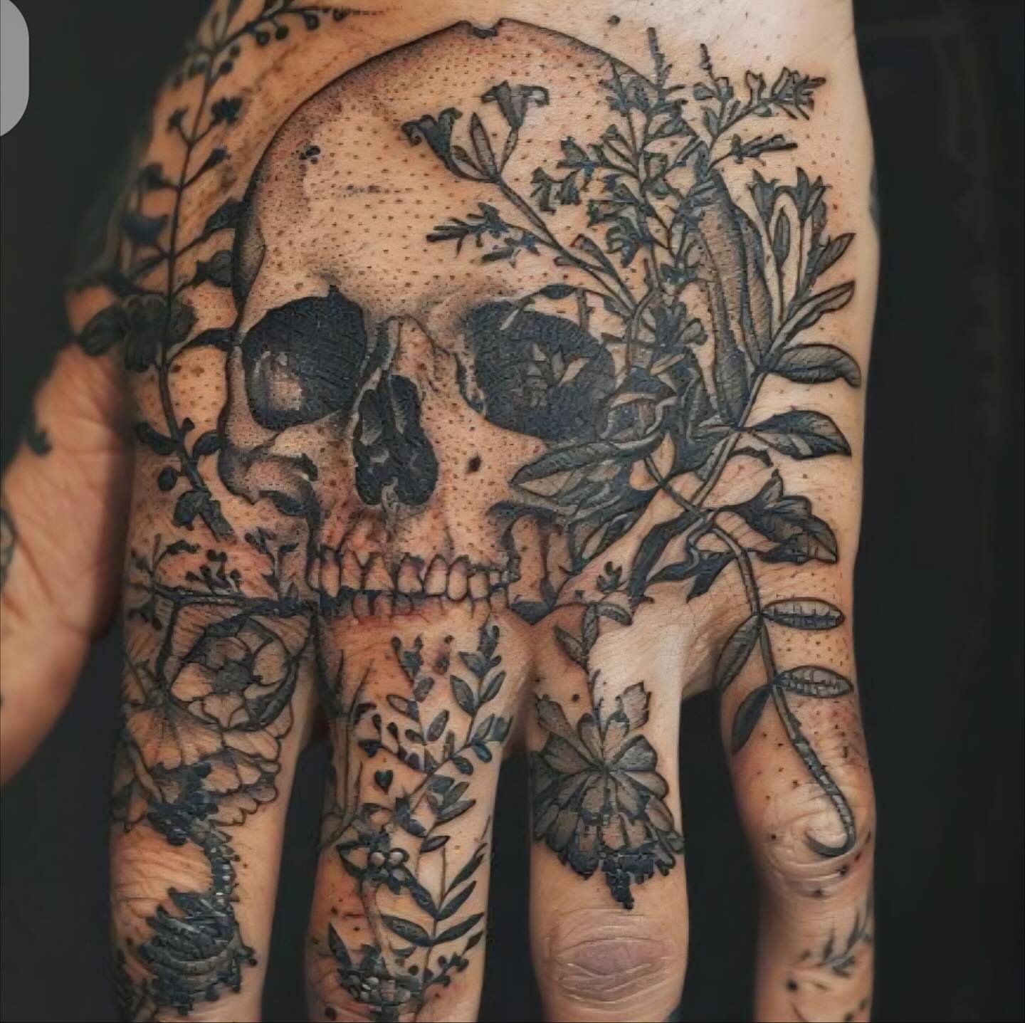 Skull and floral dotwork tattoo on the hand by Shane Montie, Killeen, Texas