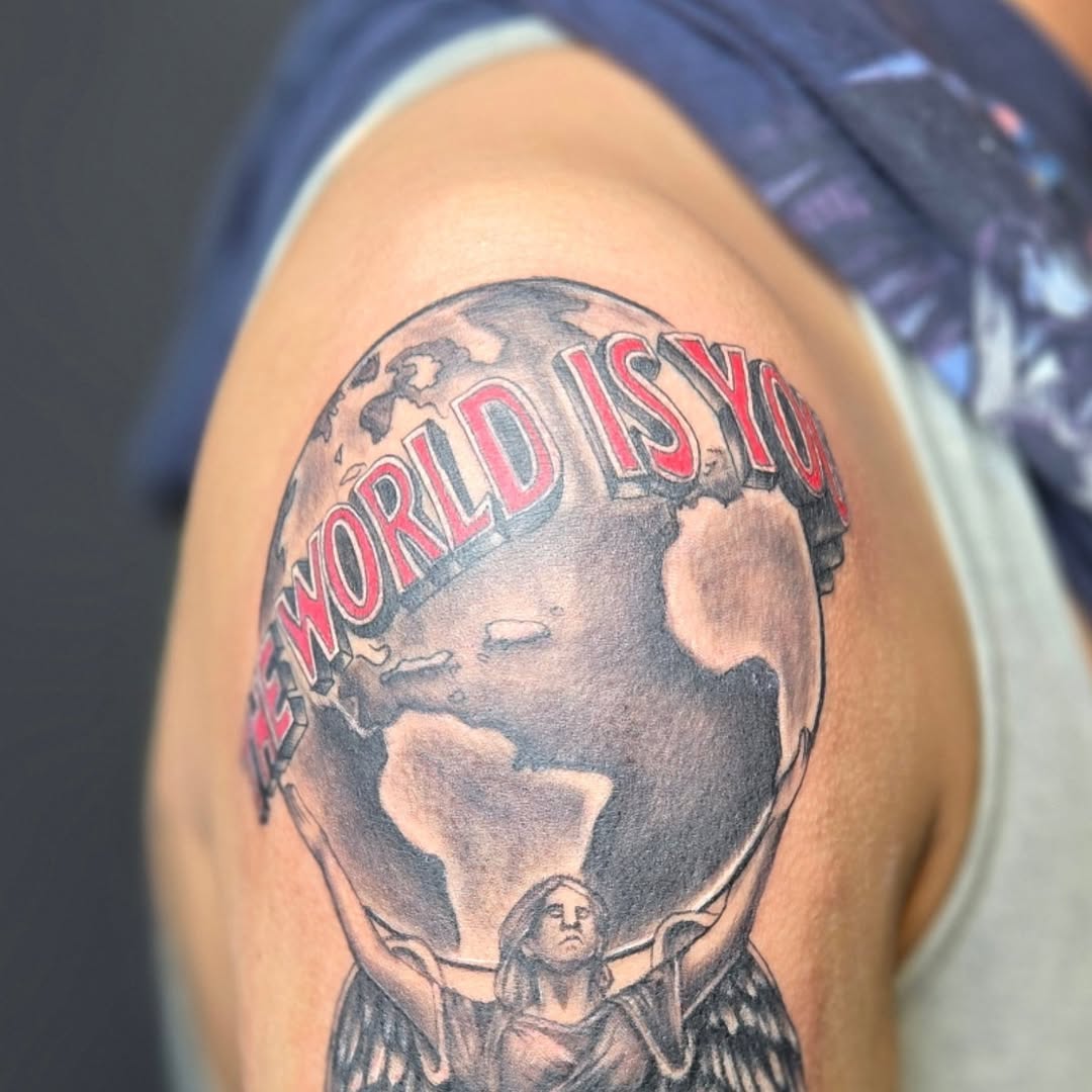 Atlas holding the world with text realism tattoo on the shoulder by Lee Styles π¨