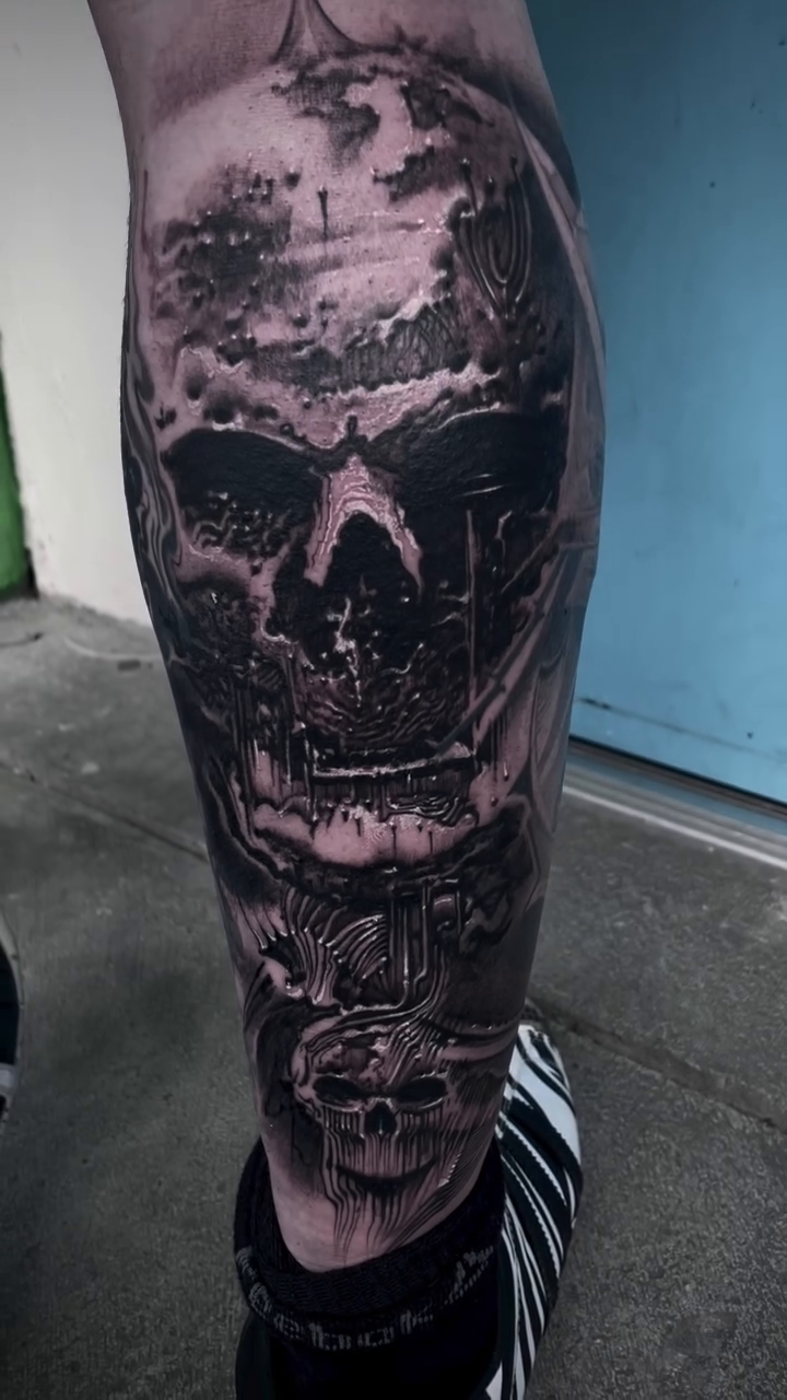 Skull with landscape dark realism tattoo by Robert Hernandez