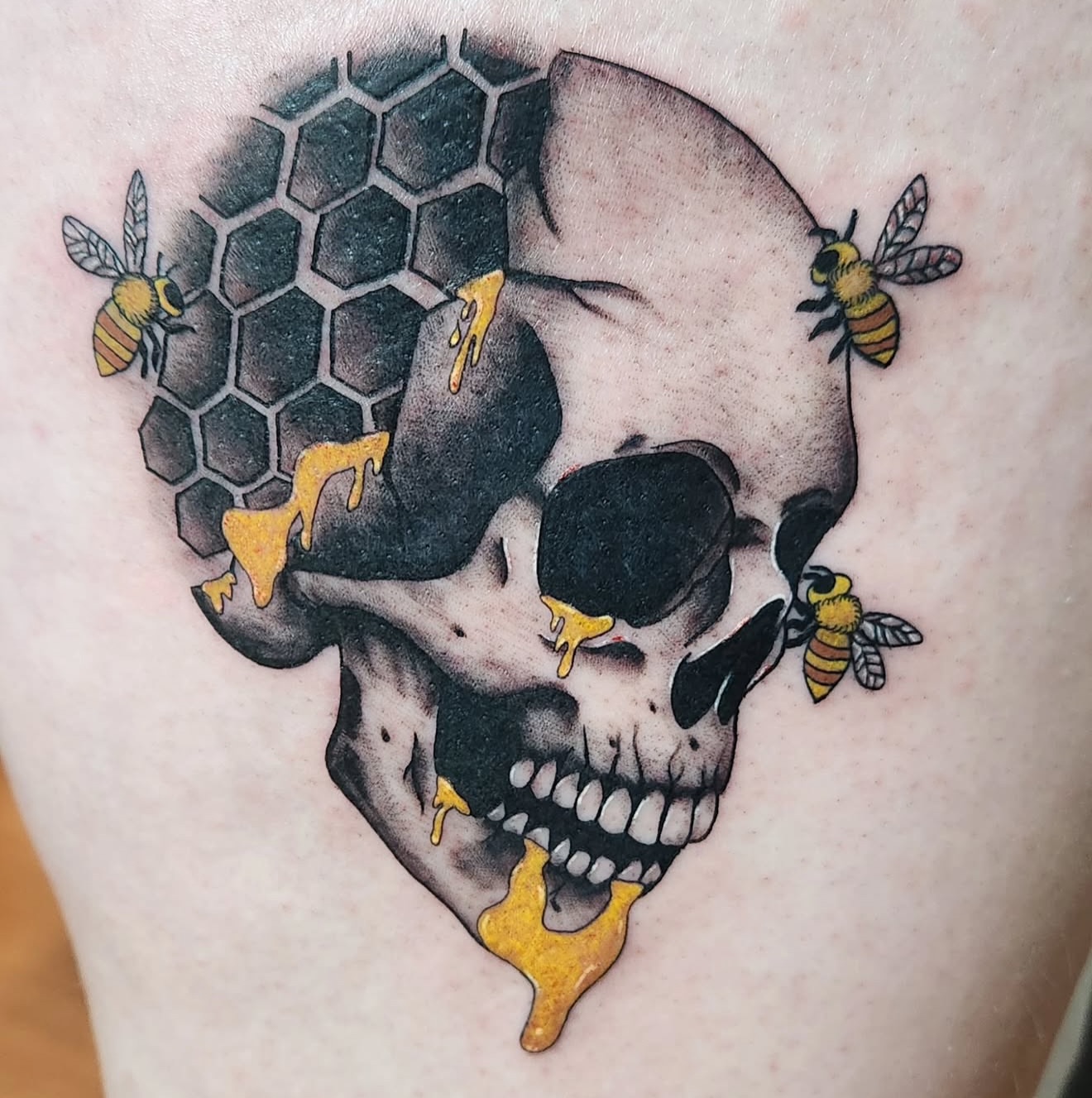 Skull with bees and honeycomb neo-traditional tattoo on the thigh by Dave Potavin, Erlanger, Kentucky