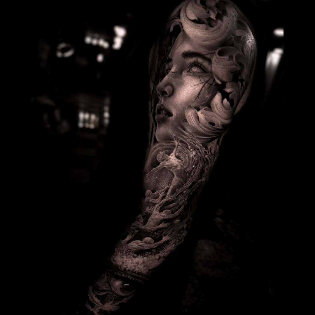 Woman's face and abstract elements realism tattoo on the forearm by Pitasso tattoo black and grey