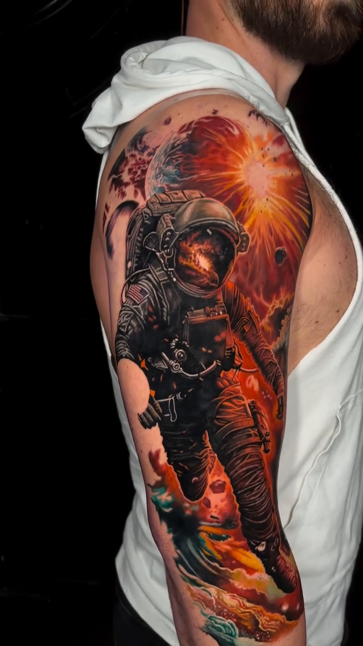 Astronaut in space realism tattoo by Jon Ronzka