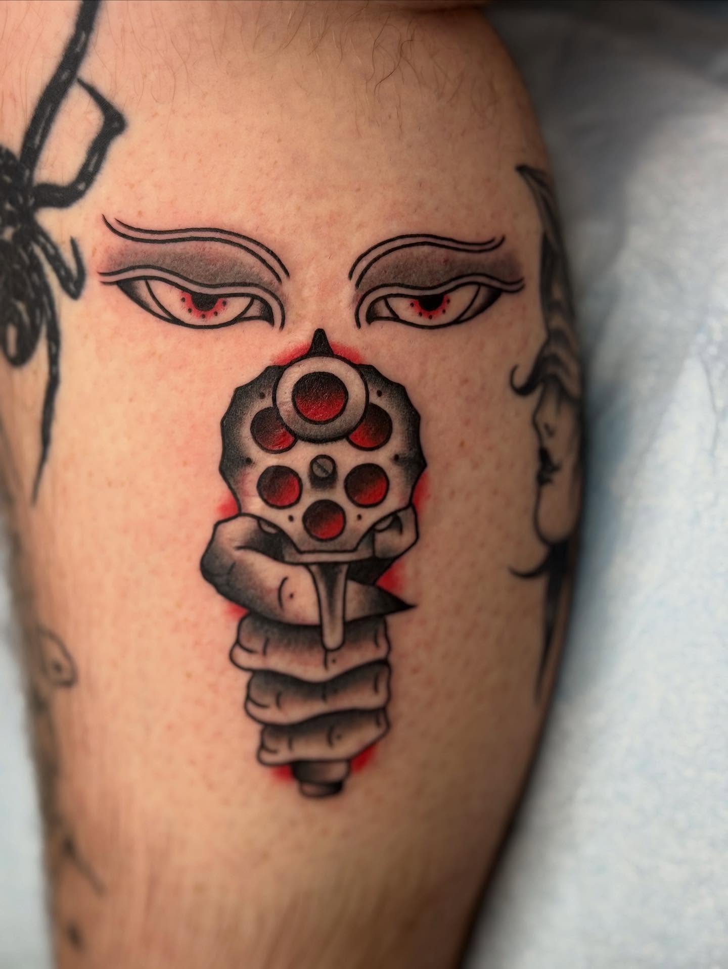 Gun and face American traditional tattoo on the forearm by π©πͺπ¬