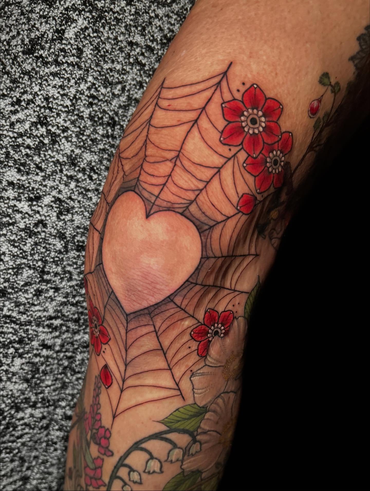 Heart and spiderweb American traditional tattoo on the forearm by Ashlee Mshar