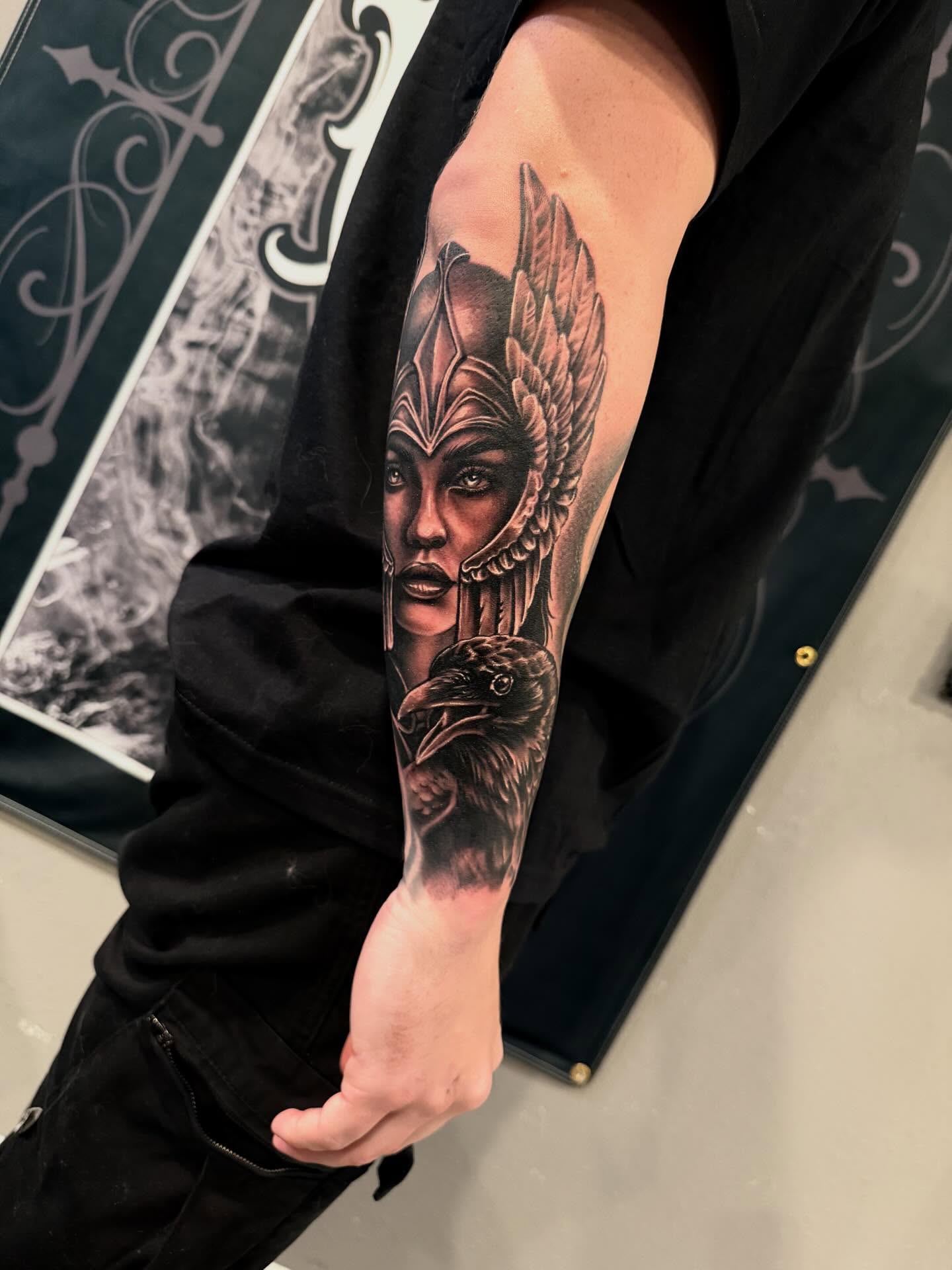 Woman with crow realism tattoo on the forearm by Cody Pappas
