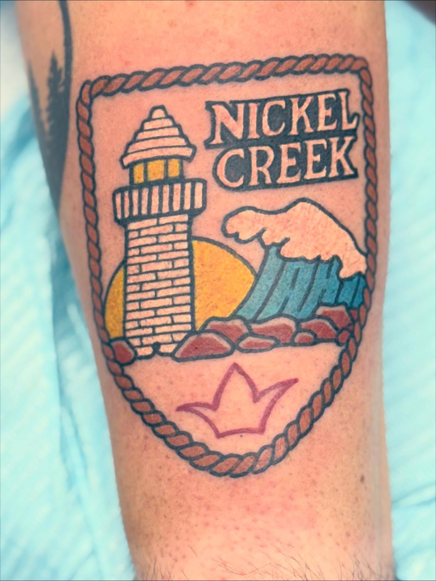 Lighthouse and wave American traditional tattoo on the forearm by Aaron Hassler, Nashville, Tennessee