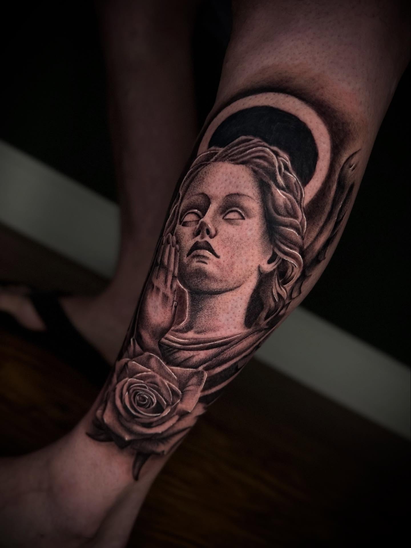 Statue head realism tattoo on the forearm by Terence Taylor