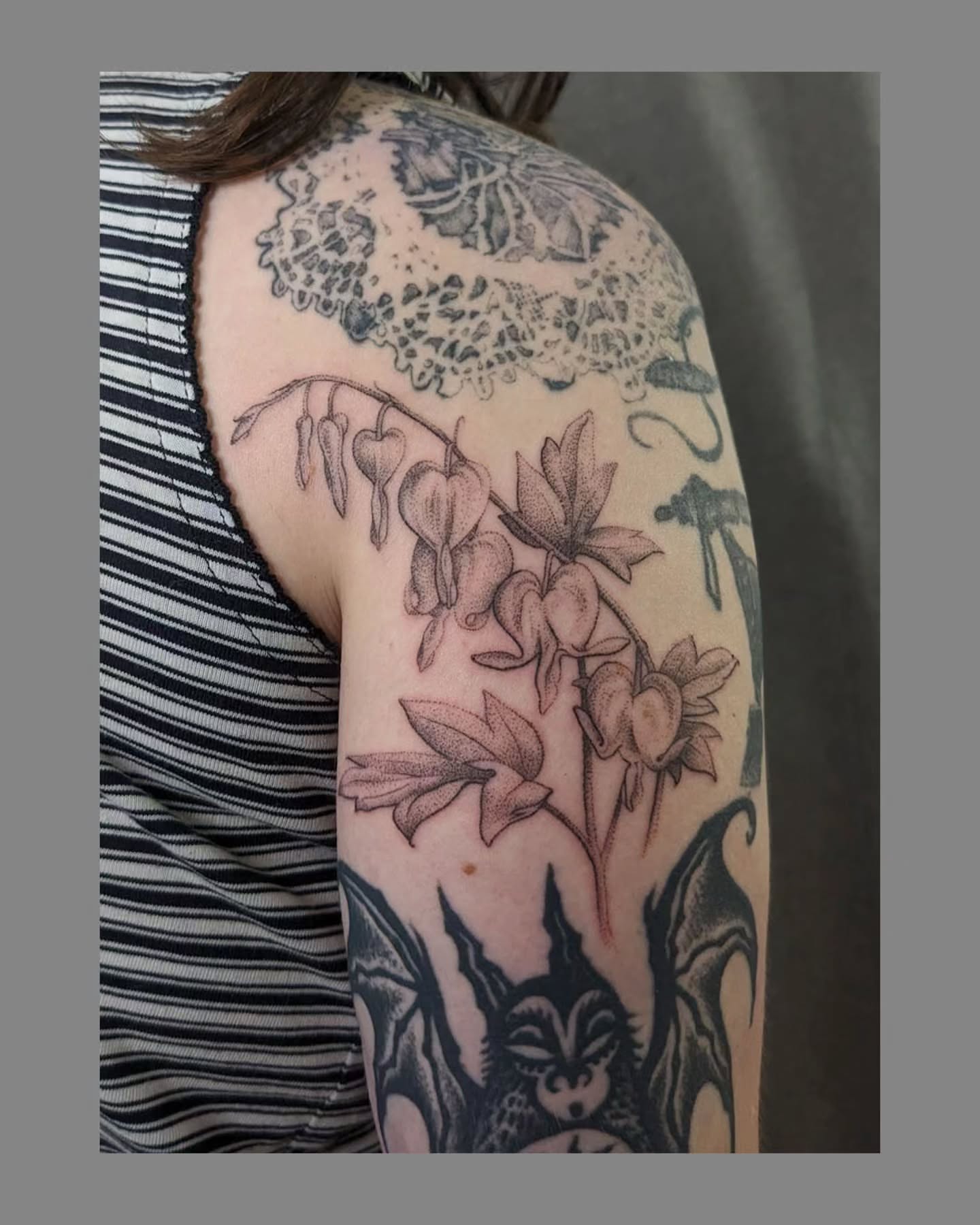Bleeding heart flowers black and grey tattoo on the shoulder by Marria