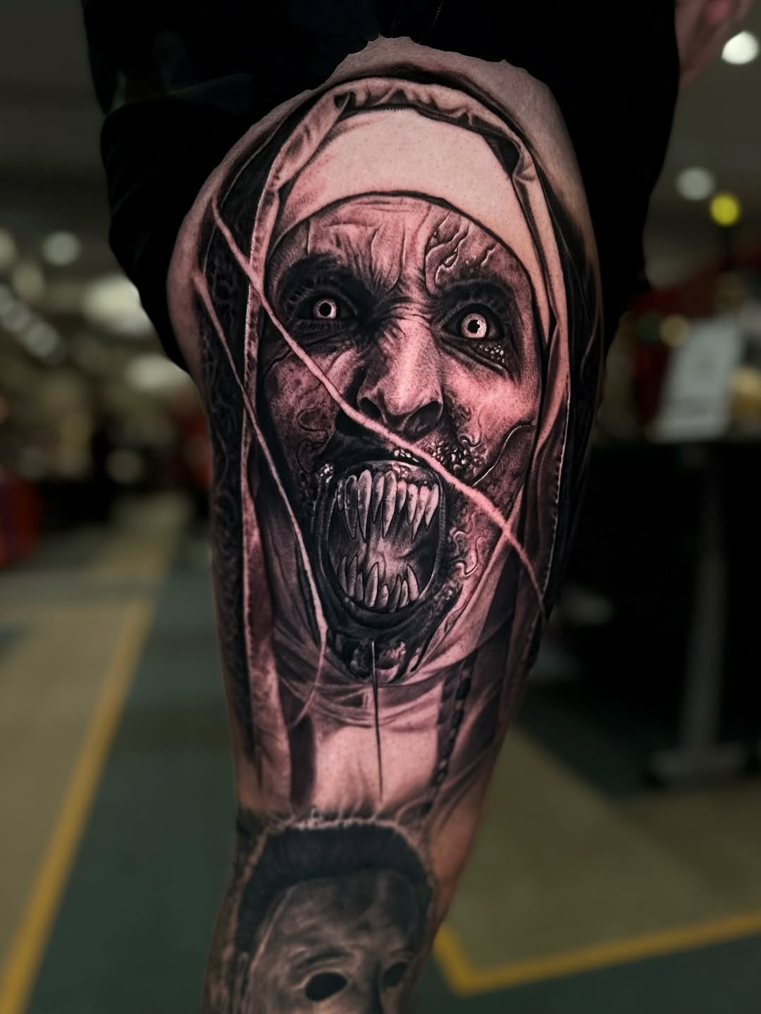 Demonic nun and Michael Myers mask realism tattoo on the forearm by Jesse White, Mentor, Ohio