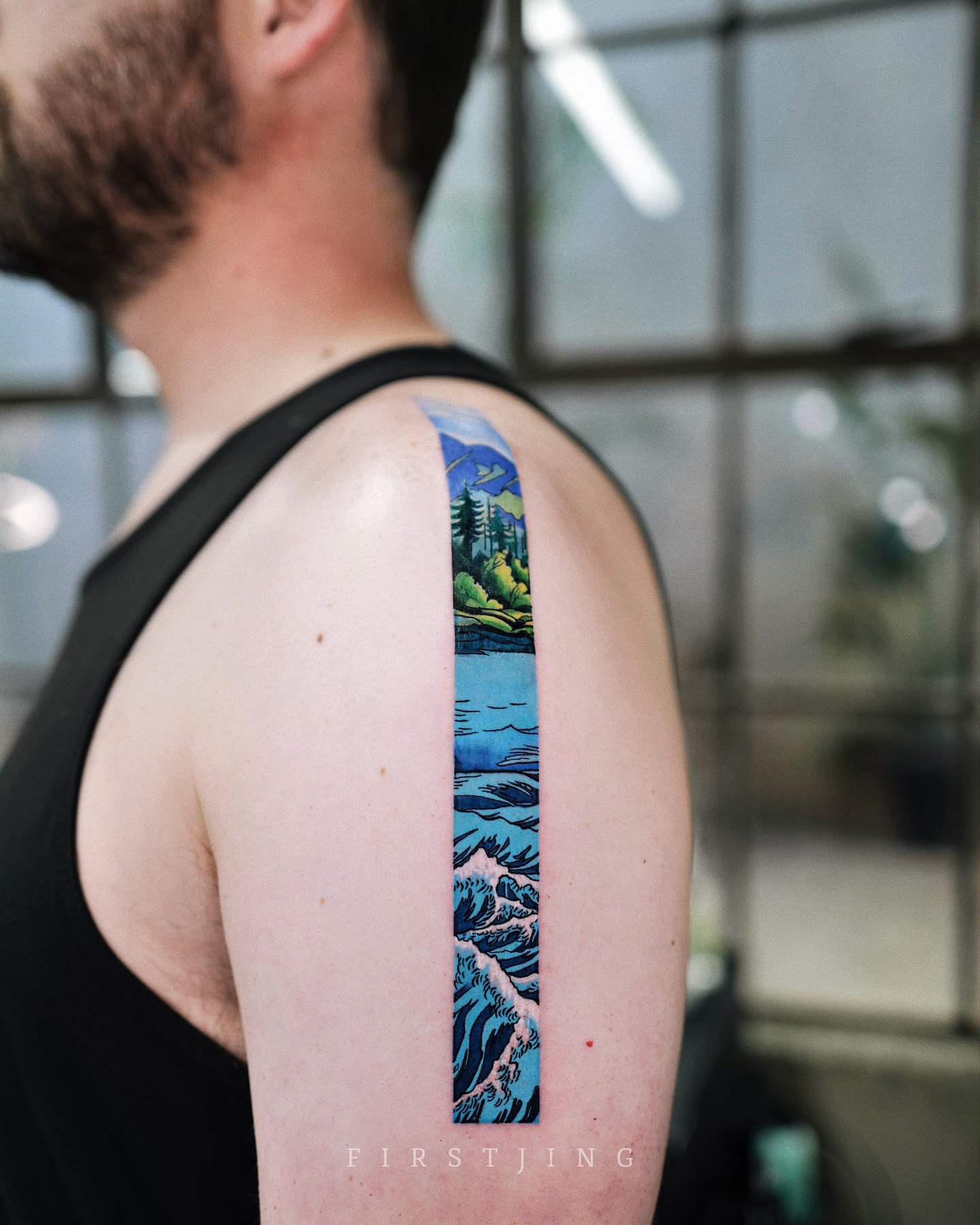 Landscape illustrative tattoo on the upper arm by Seattle
