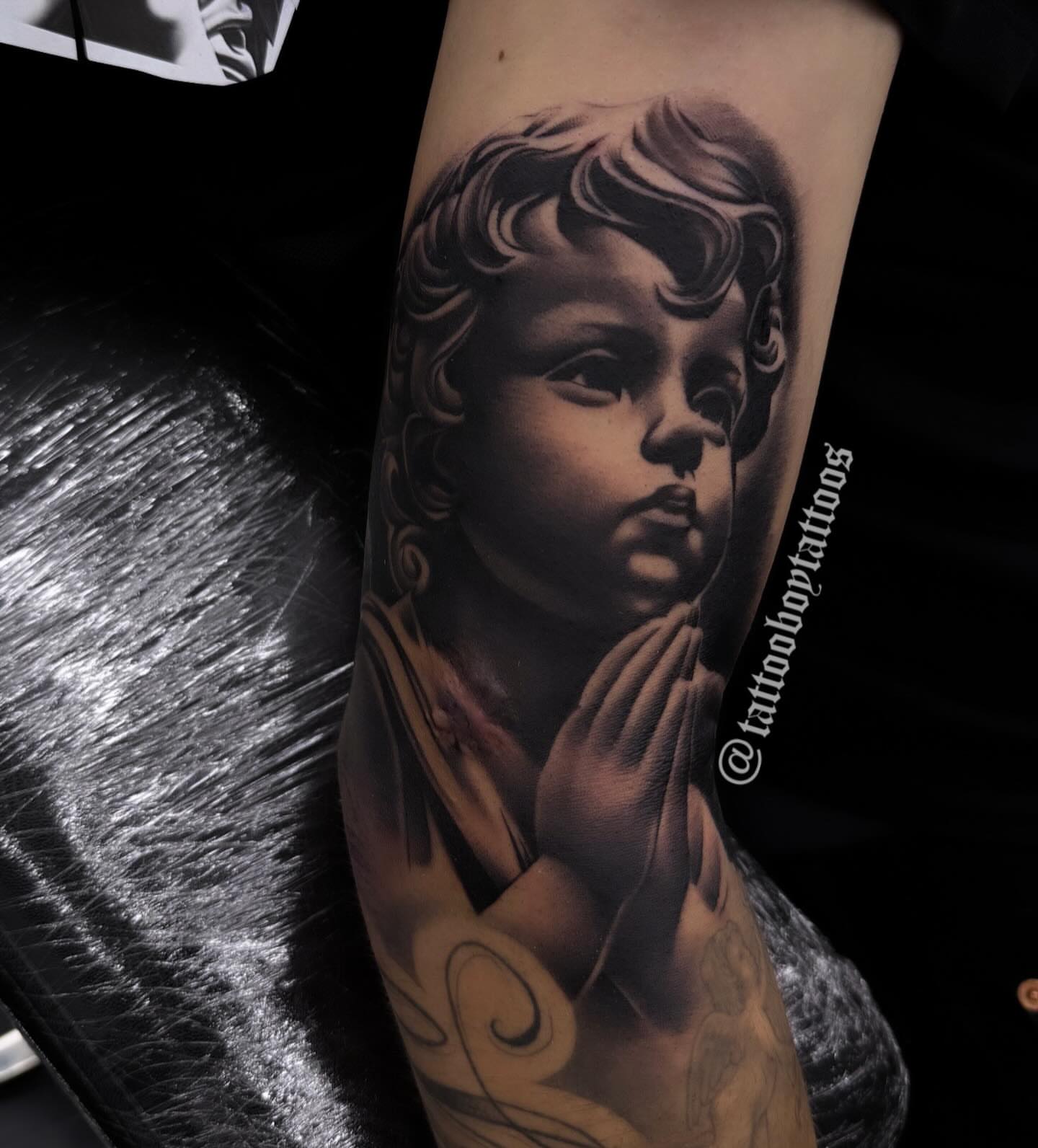 Child praying realism tattoo on the forearm by TattooBoyTattoos